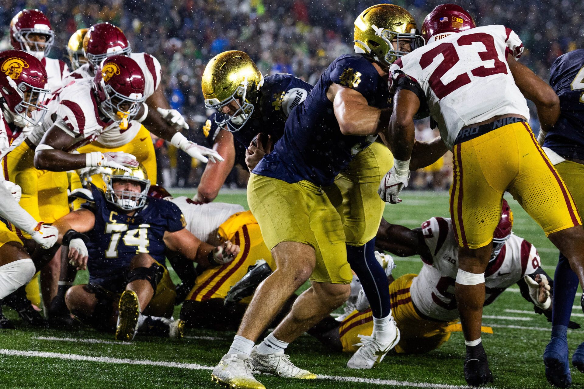 Notre Dame Fighting Irish quarterback CJ Carr (13) runs the ball for a touchdown while Southern California Trojans linebacker Desman Stephens II (23) defends in the second half at Notre Dame Stadium.
