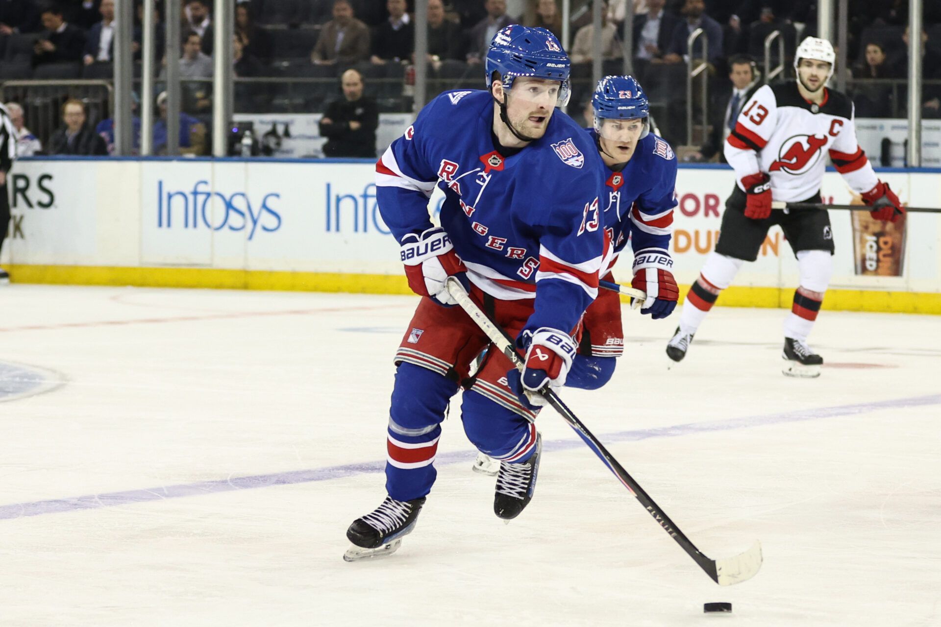 New York Rangers left wing Alexis Lafrenière (13) controls the puck in the third period against the New Jersey Devils at Madison Square Garden.