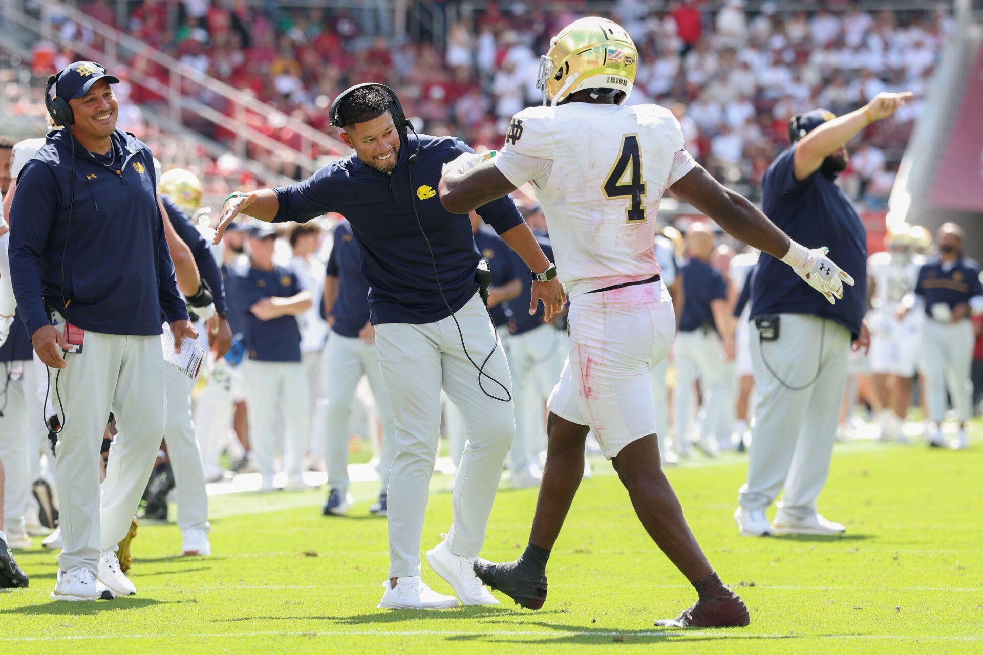Notre Dame Fighting Irish head coach Marcus Freeman celebrates with running back Jeremiyah Love (4) after a touchdown in the second quarter against the Arkansas Razorbacks at Donald W. Reynolds Razorback Stadium.