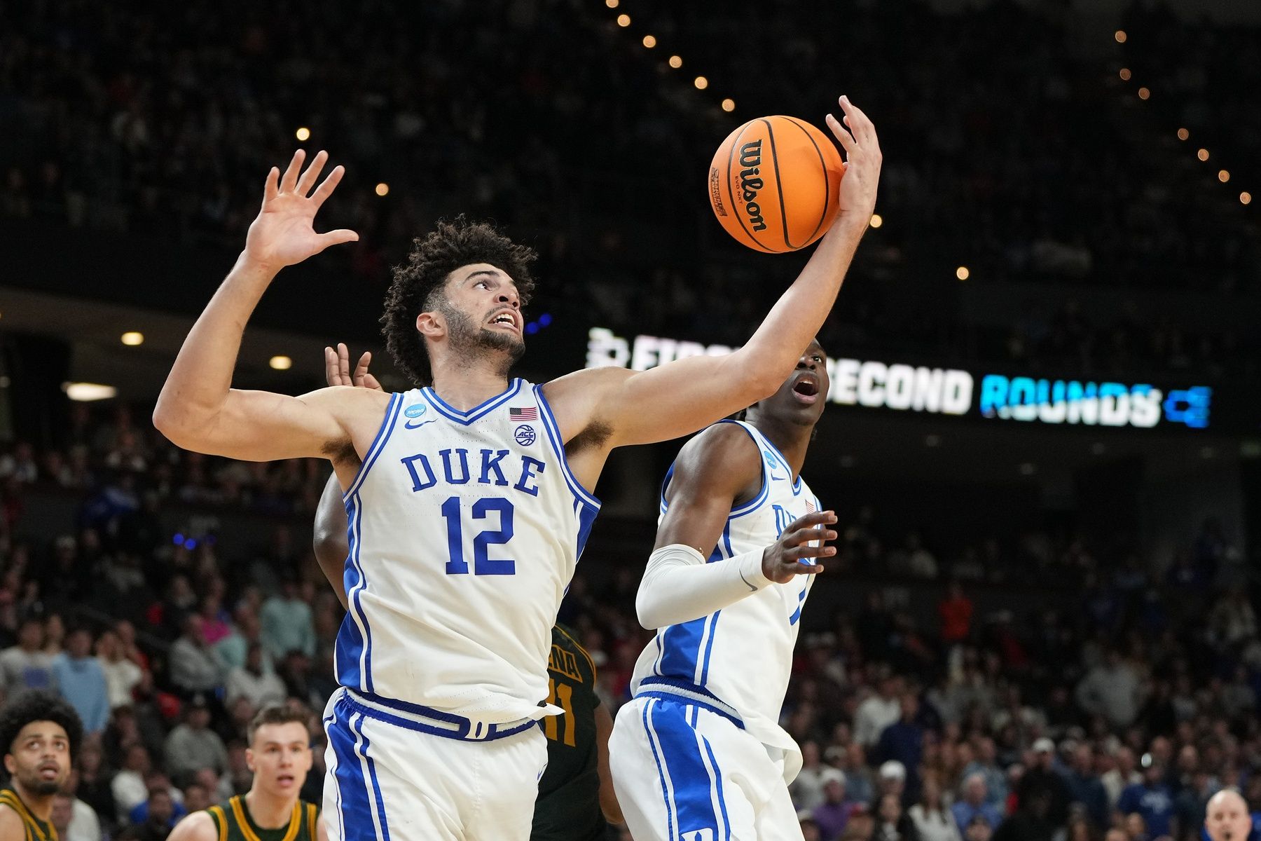 Duke Blue Devils forward Cameron Boozer (12) grabs a rebound against the Siena Saints in the second half during a first round game of the men's 2026 NCAA Tournament at Bon Secours Wellness Arena.