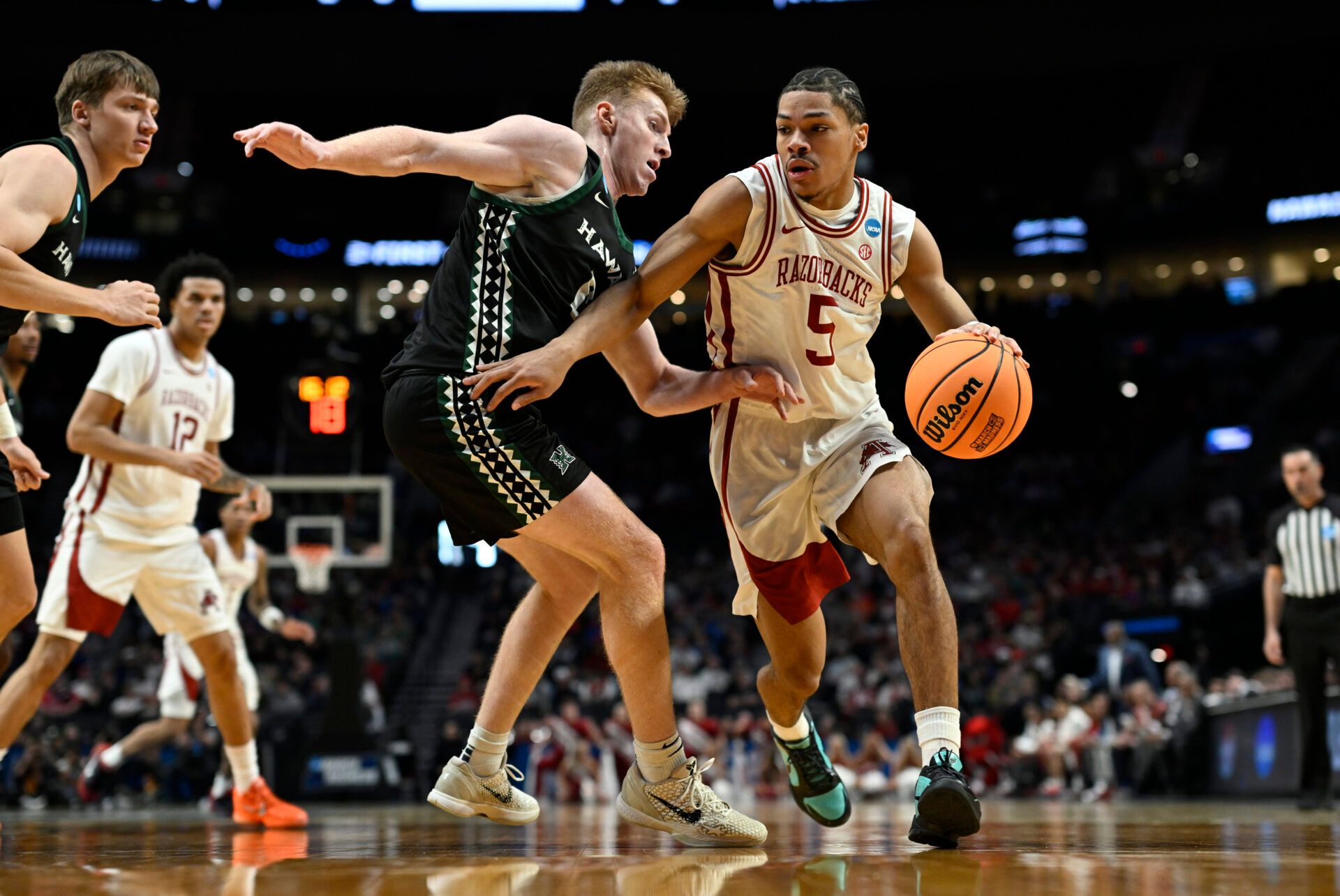 Arkansas Razorbacks guard Darius Acuff Jr. (5) drives against Hawaii Rainbow Warriors guard Hunter Erickson (0) in the first half during a first round game of the men's 2026 NCAA Tournament at Moda Center.