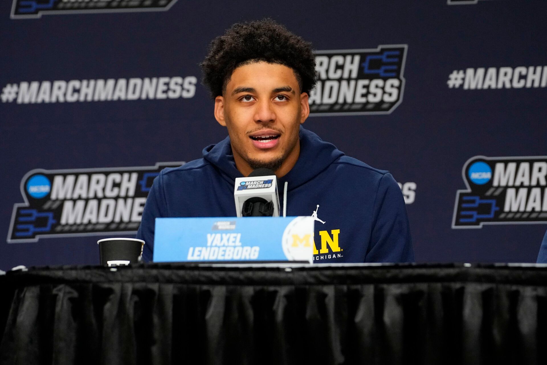 Michigan Wolverines forward Yaxel Lendeborg (23) answers questions during the press conference prior to their practice session ahead of the first round of the men's 2026 NCAA Tournament at Keybank Center.