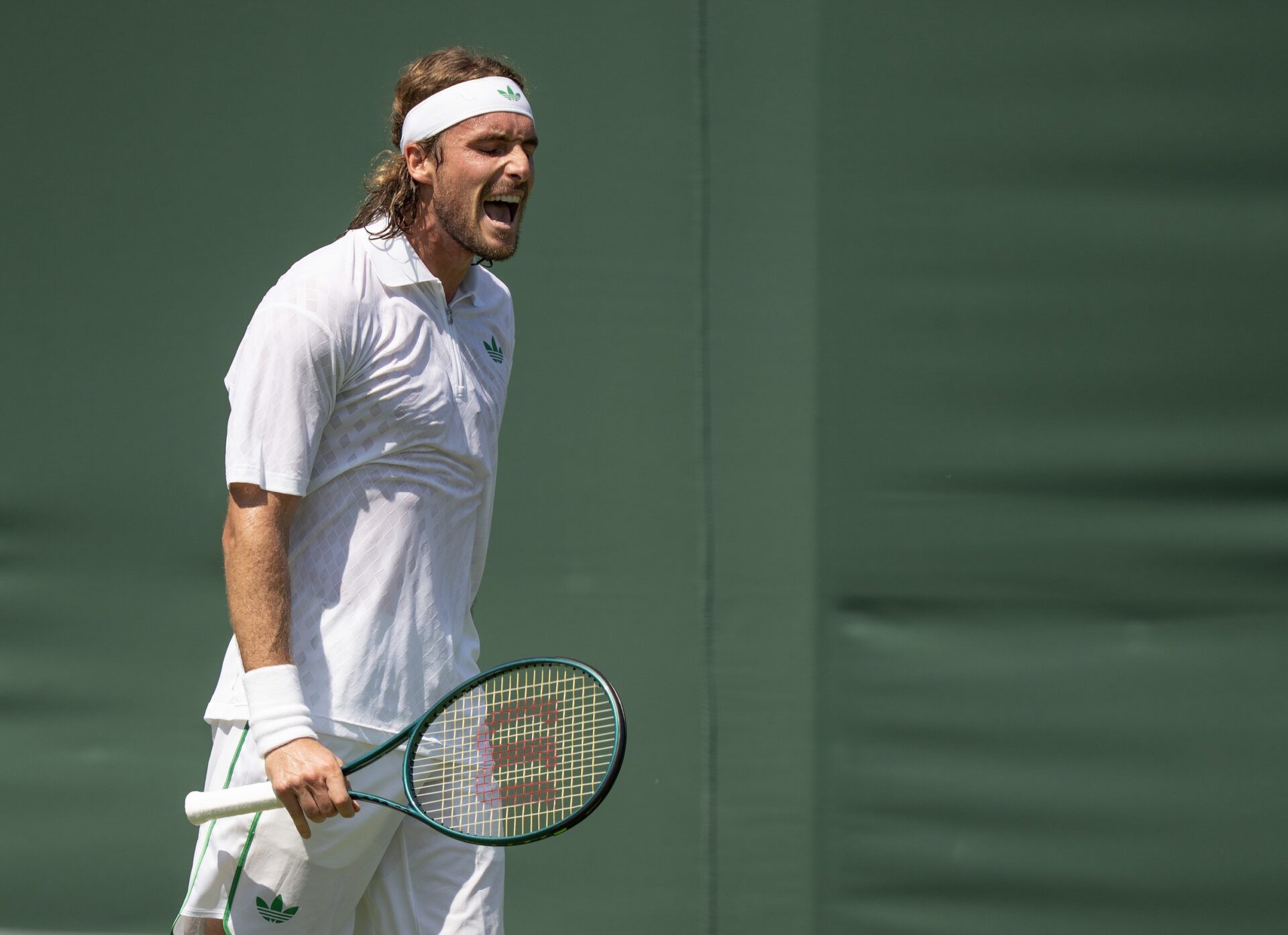 Stefanos Tsitsipas of Greece reacts to a point during his match against Valentin Royer of France on day one at the All England Lawn Tennis and Croquet Club.