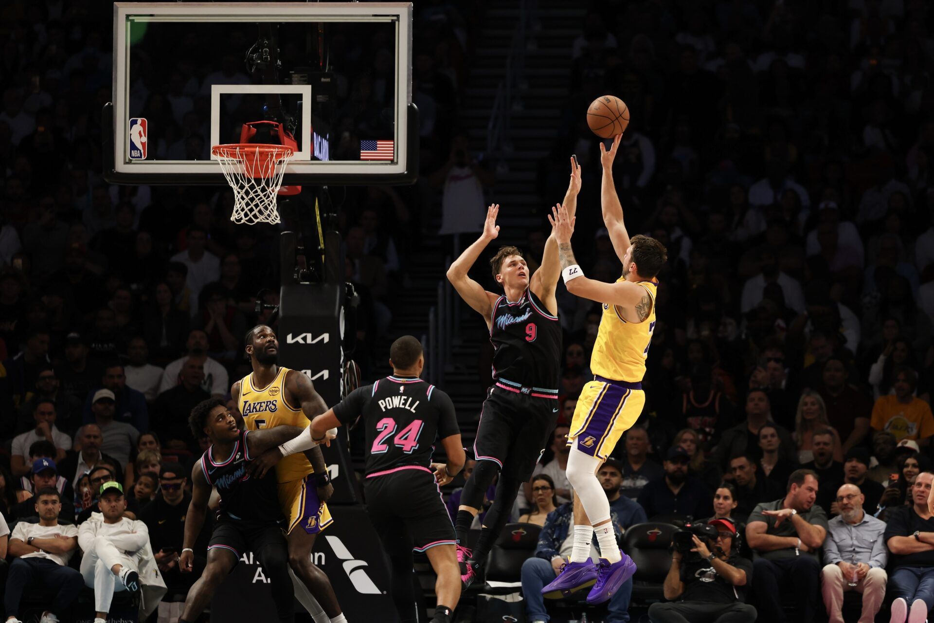 Los Angeles Lakers guard Luka Doncic (77) shoots over Miami Heat guard Pelle Larsson (9) during second half against the Miami Heat at Kaseya Center.