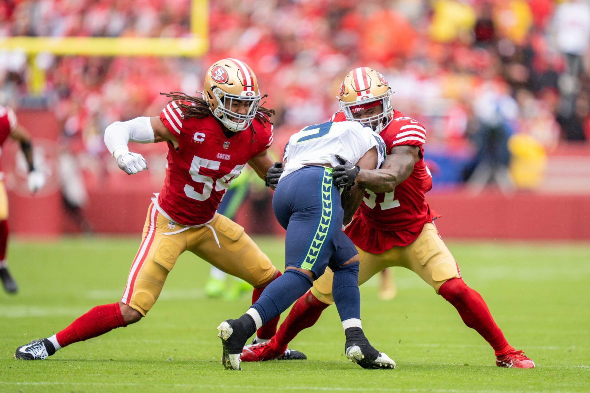 San Francisco 49ers linebacker Fred Warner (54) and linebacker Dre Greenlaw (57) tackle Seattle Seahawks running back Kenneth Walker III (9) during the third quarter at Levi's Stadium.
