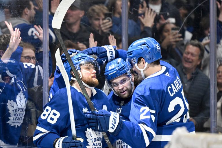 Toronto Maple Leafs forward William Nylander (88) celebrates with defenseman Brando Carlo (25) and forward Matias Maccelli (63) after scoring a goal against the Carolina Hurricanes in the third period at Scotiabank Arena.