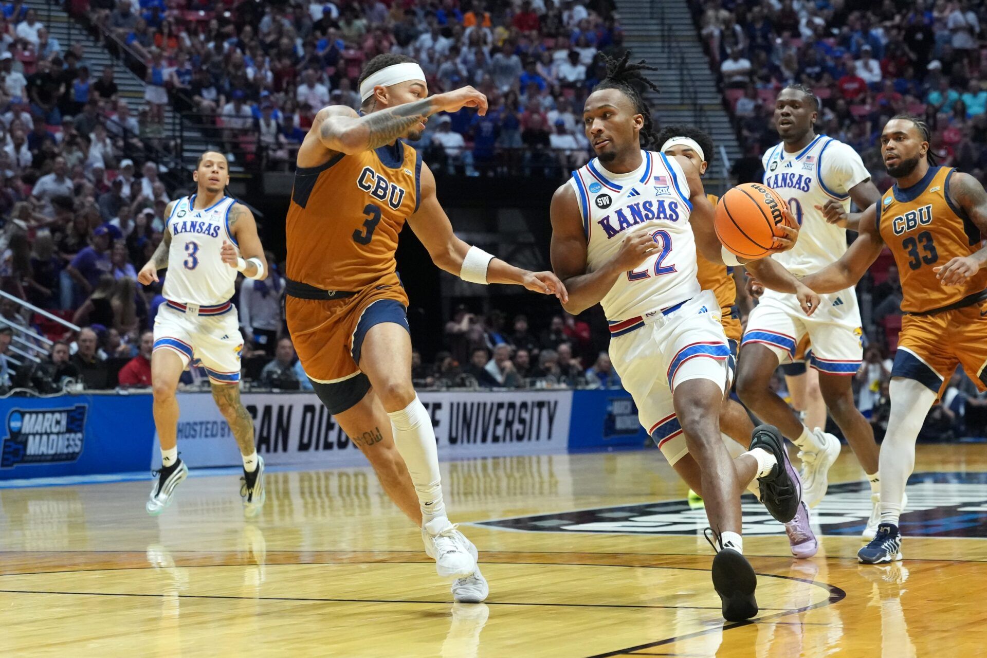 Kansas Jayhawks guard Darryn Peterson (22) controls the ball against California Baptist Lancers guard Jayden Jackson (3) in the first half during a first round game of the men's 2026 NCAA Tournament at Viejas Arena.