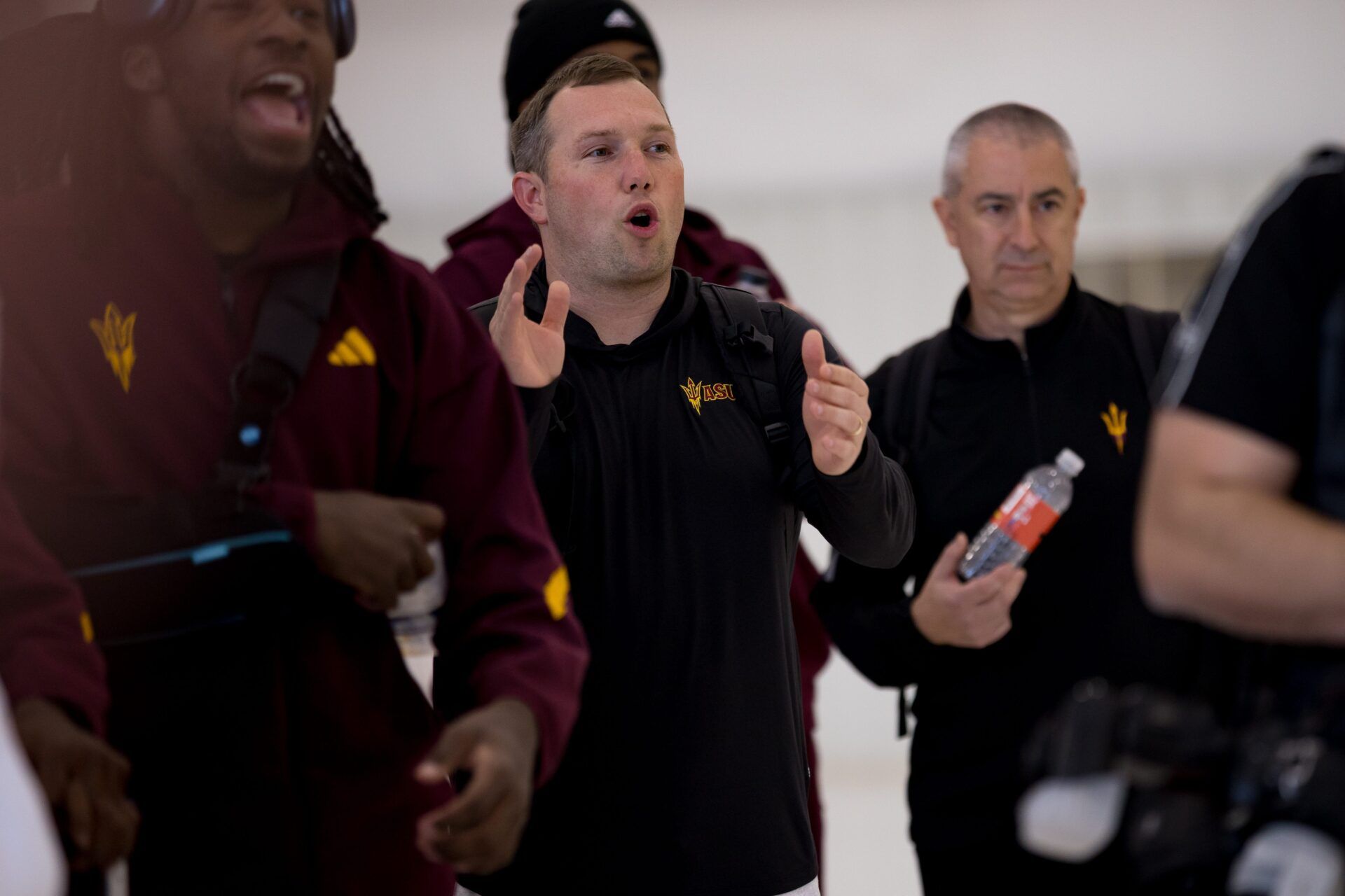 Arizona State head football coach Kenny Dillingham watches folklórico dancers perform as they arrive at the Atlantic FBO Hangar in El Paso, Texas, on Saturday, Dec. 27, 2025, ahead of the Tony the Tiger Sun Bowl.