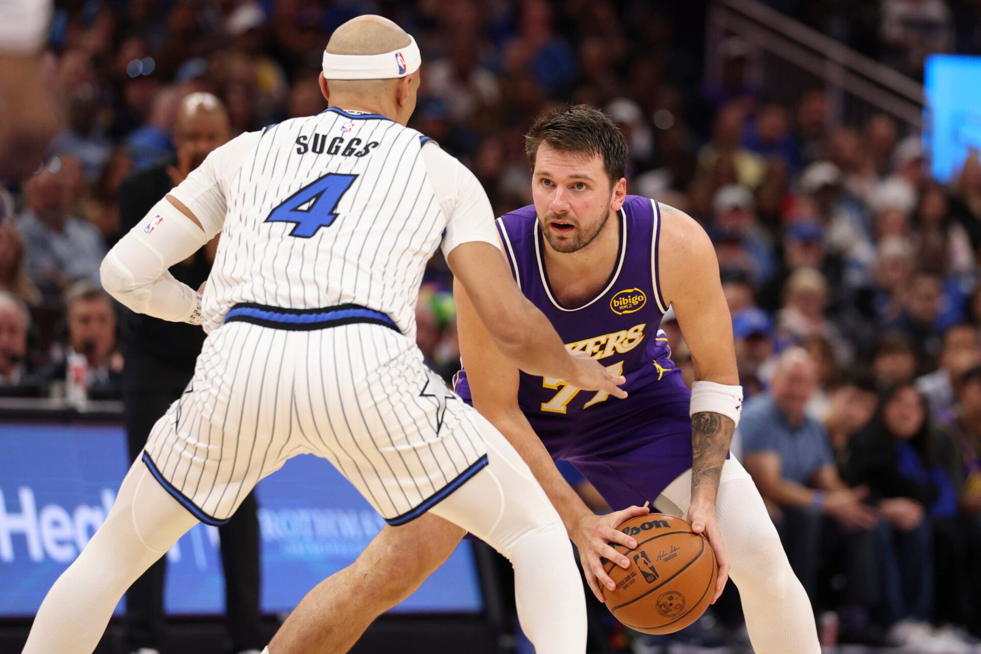 Los Angeles Lakers guard Luka Doncic (77) is guarded by Orlando Magic guard Jalen Suggs (4) in the second quarter at Kia Center.
