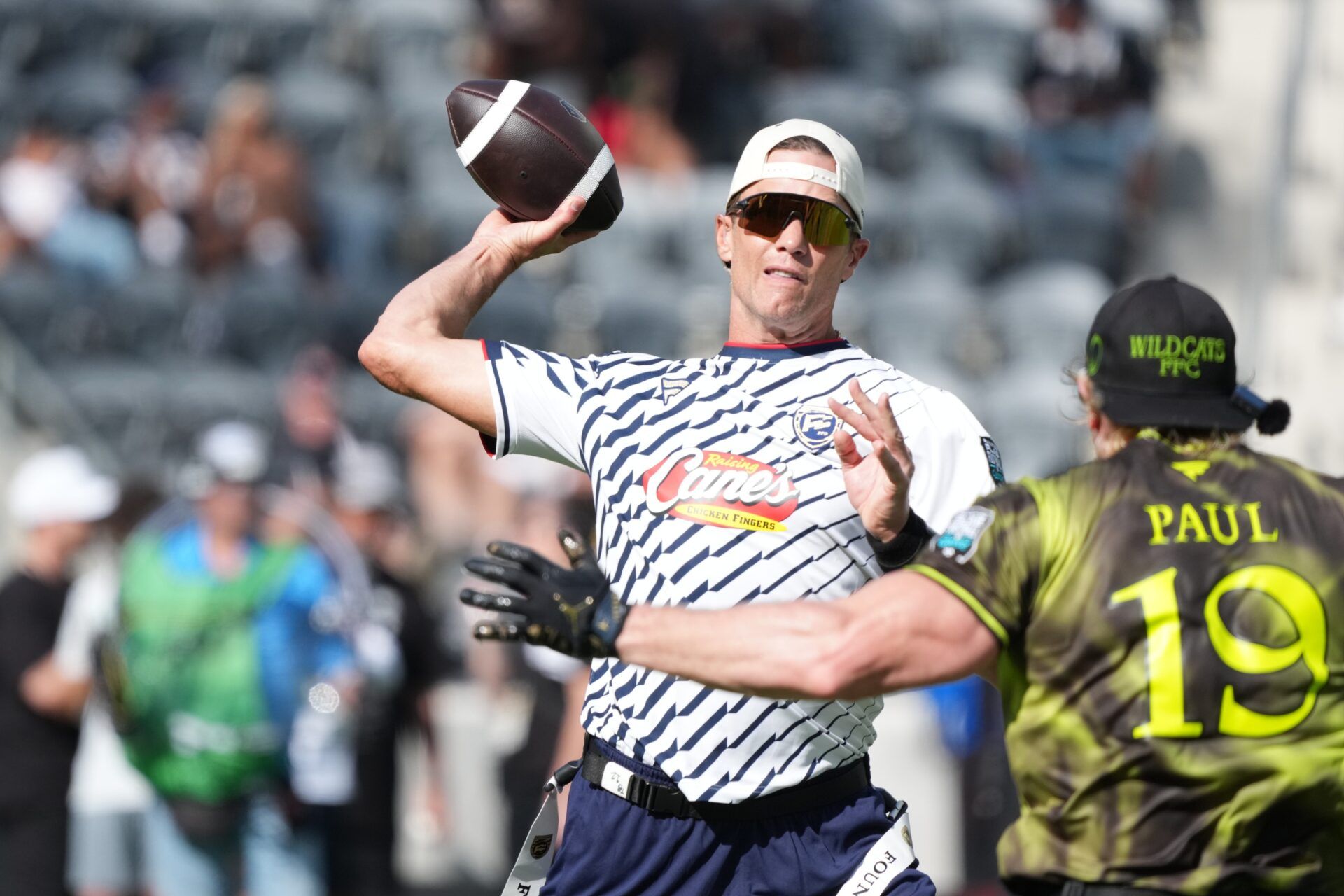 Founders FFC quarterback Tom Brady (12) throws ball against Logan Paul of Wildcats FFC during the Fanatics Flag Football Classic at BMO stadium.