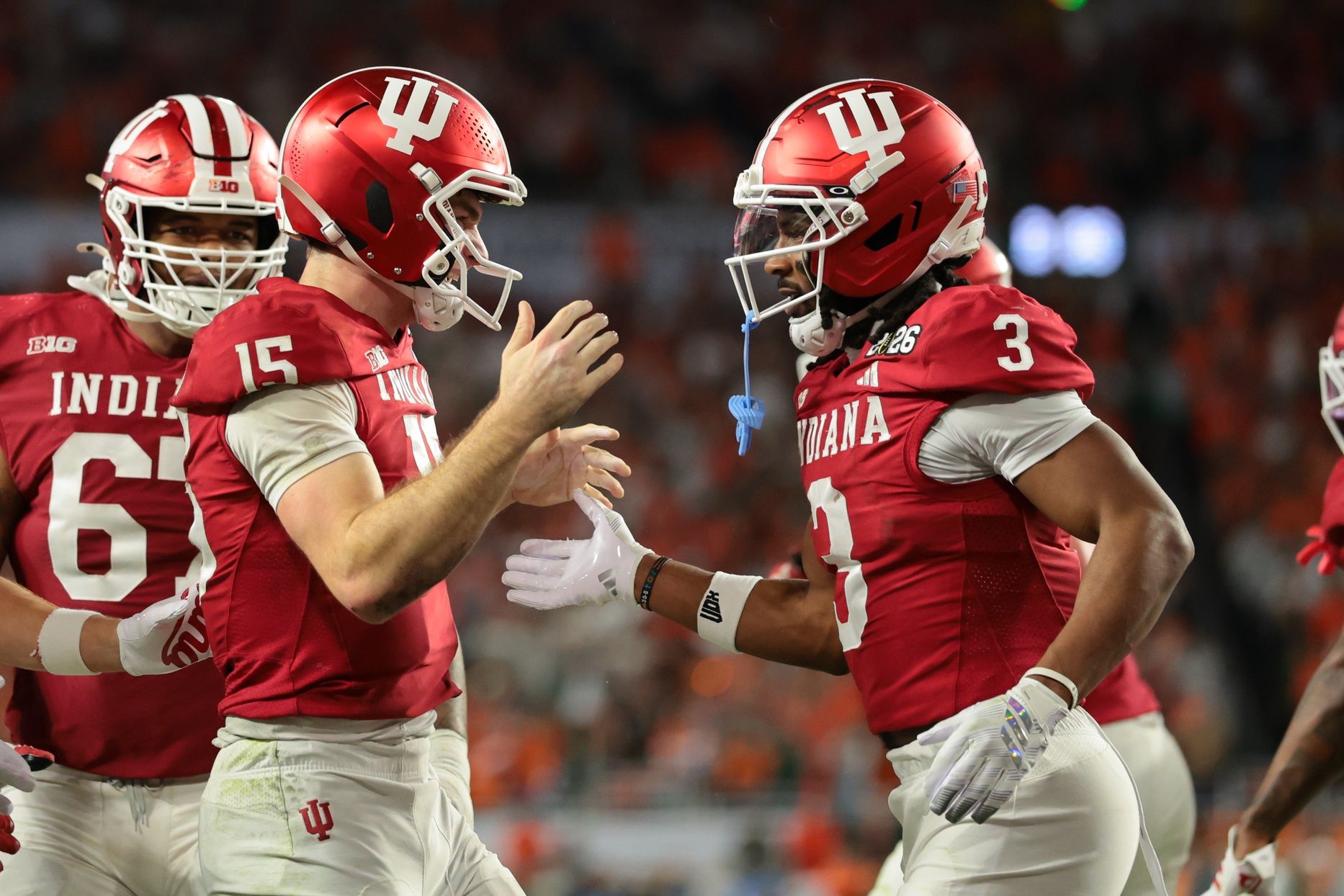 Indiana Hoosiers quarterback Fernando Mendoza (15) celebrates with wide receiver Omar Cooper Jr. (3) after scoring a touchdown against the Miami Hurricanes in the fourth quarter during the College Football Playoff National Championship game at Hard Rock Stadium.