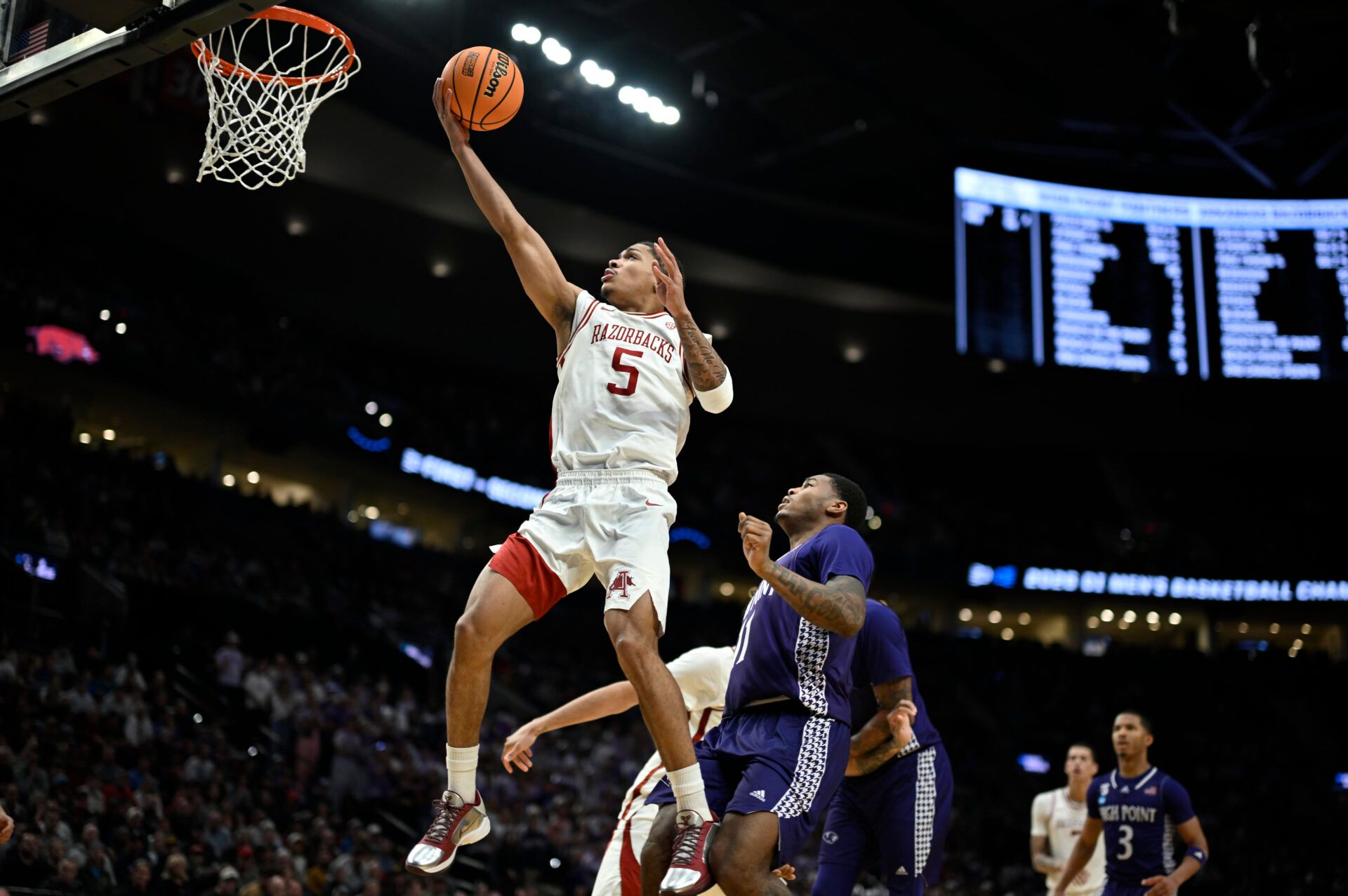 Arkansas Razorbacks guard Darius Acuff Jr. (5) shoots against High Point Panthers forward Cam'ron Fletcher (11) in the second half during a second round game of the men's 2026 NCAA Tournament at Moda Center.