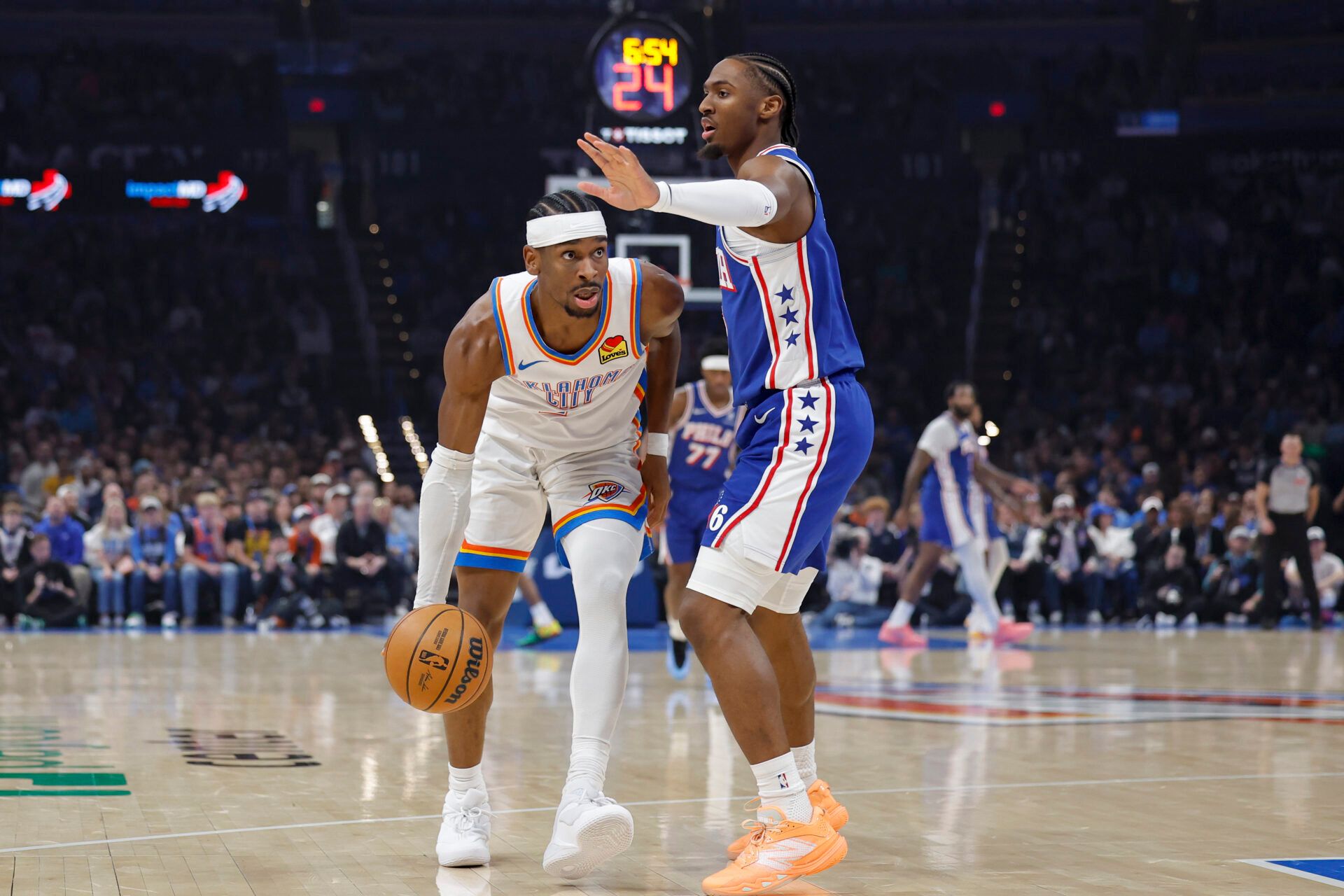 Oklahoma City Thunder guard Shai Gilgeous-Alexander (2) moves the ball past Philadelphia 76ers guard Tyrese Maxey (0) during the first quarter at Paycom Center.
