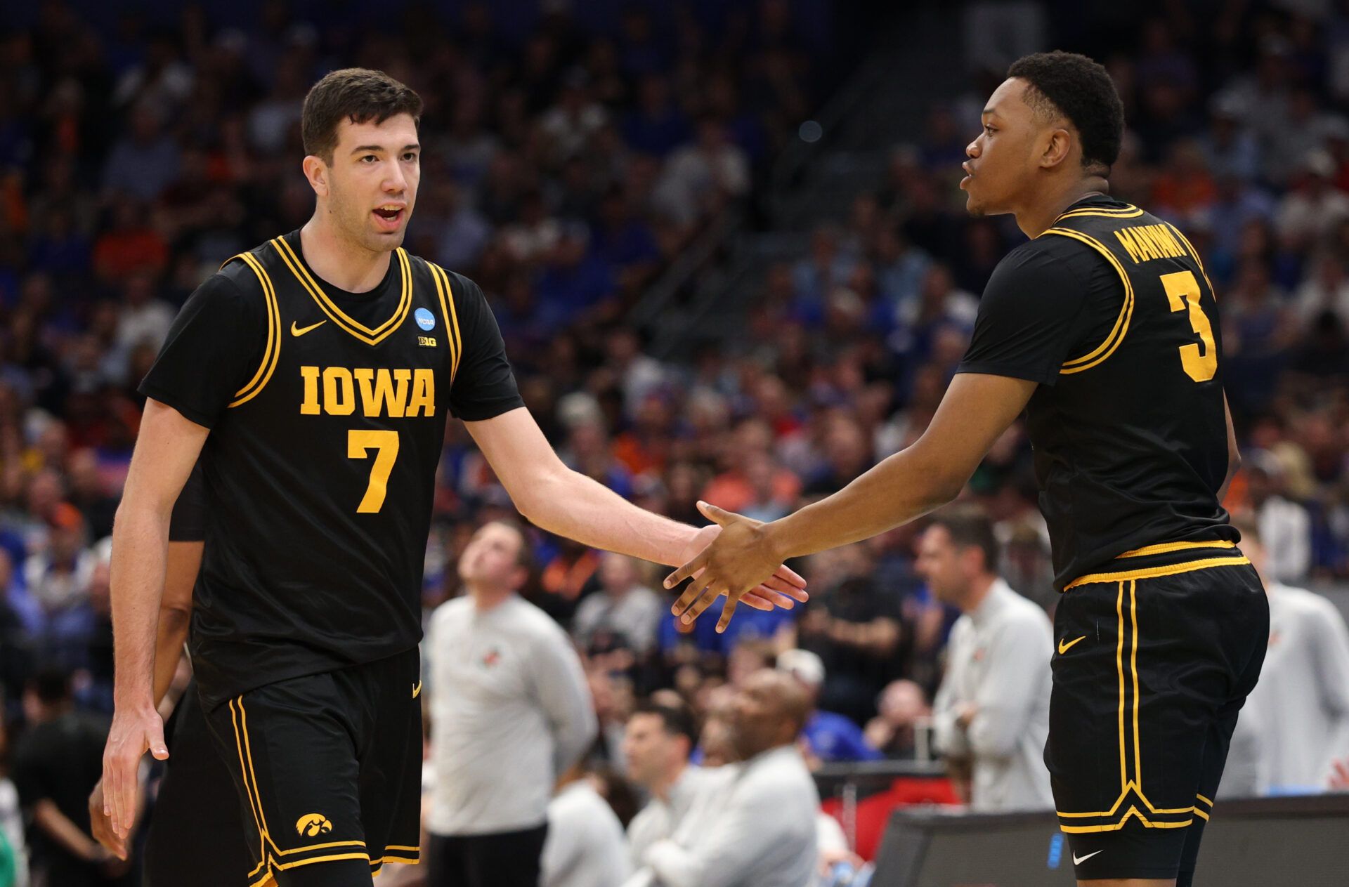 Iowa Hawkeyes forward Alvaro Folgueiras (7) high-fives Iowa Hawkeyes forward Cam Manyawu (3) against the Florida Gators in the second half during a second round game of the men's 2026 NCAA Tournament at Benchmark International Arena.