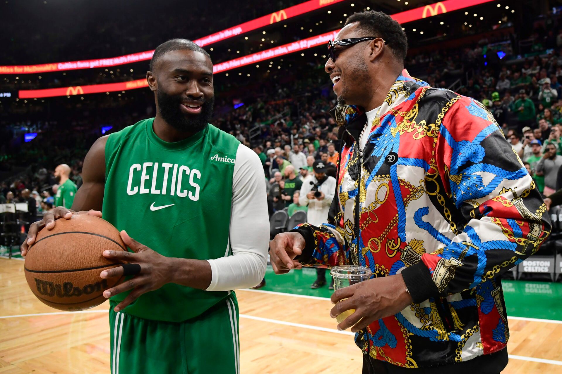 Boston Celtics guard Jaylen Brown (7) and former Celtics Paul Pierce talk before a game against the Minnesota Timberwolves at TD Garden.