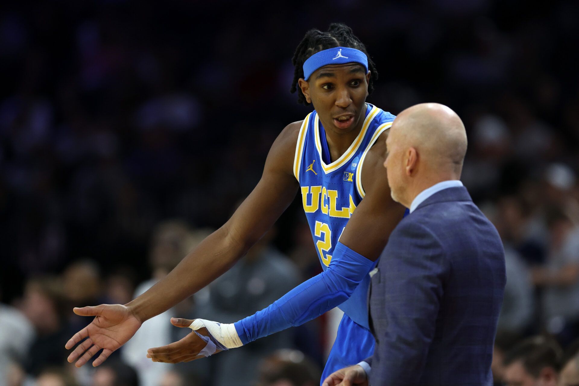 UCLA Bruins center Steven Jamerson II (24) reacts with head coach Mick Cronin  in the first half during a second round game of the men's 2026 NCAA Tournament at Xfinity Mobile Arena.