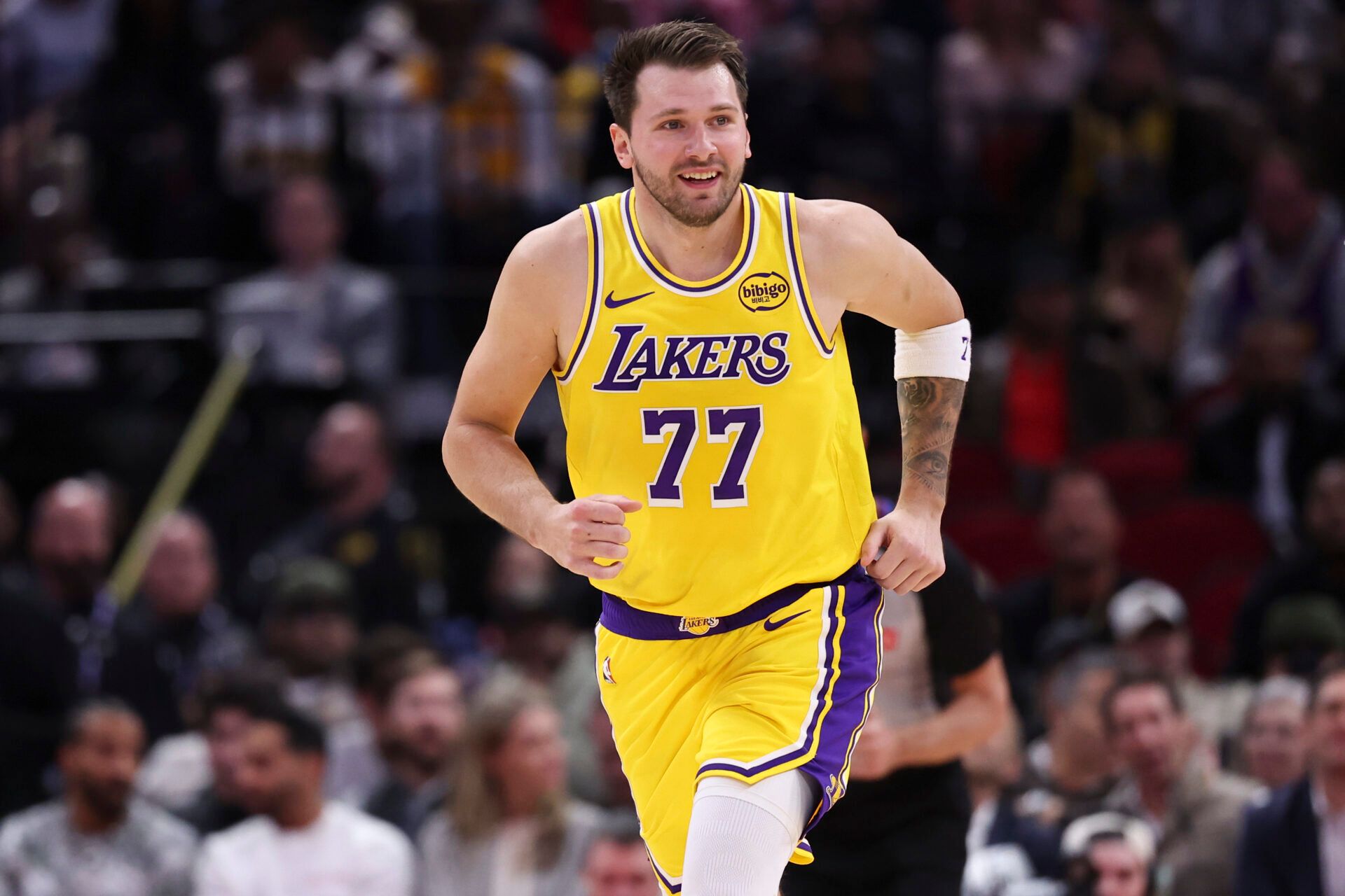 Los Angeles Lakers guard Luka Doncic (77) reacts after scoring a basket during the first quarter against the Houston Rockets at Toyota Center.