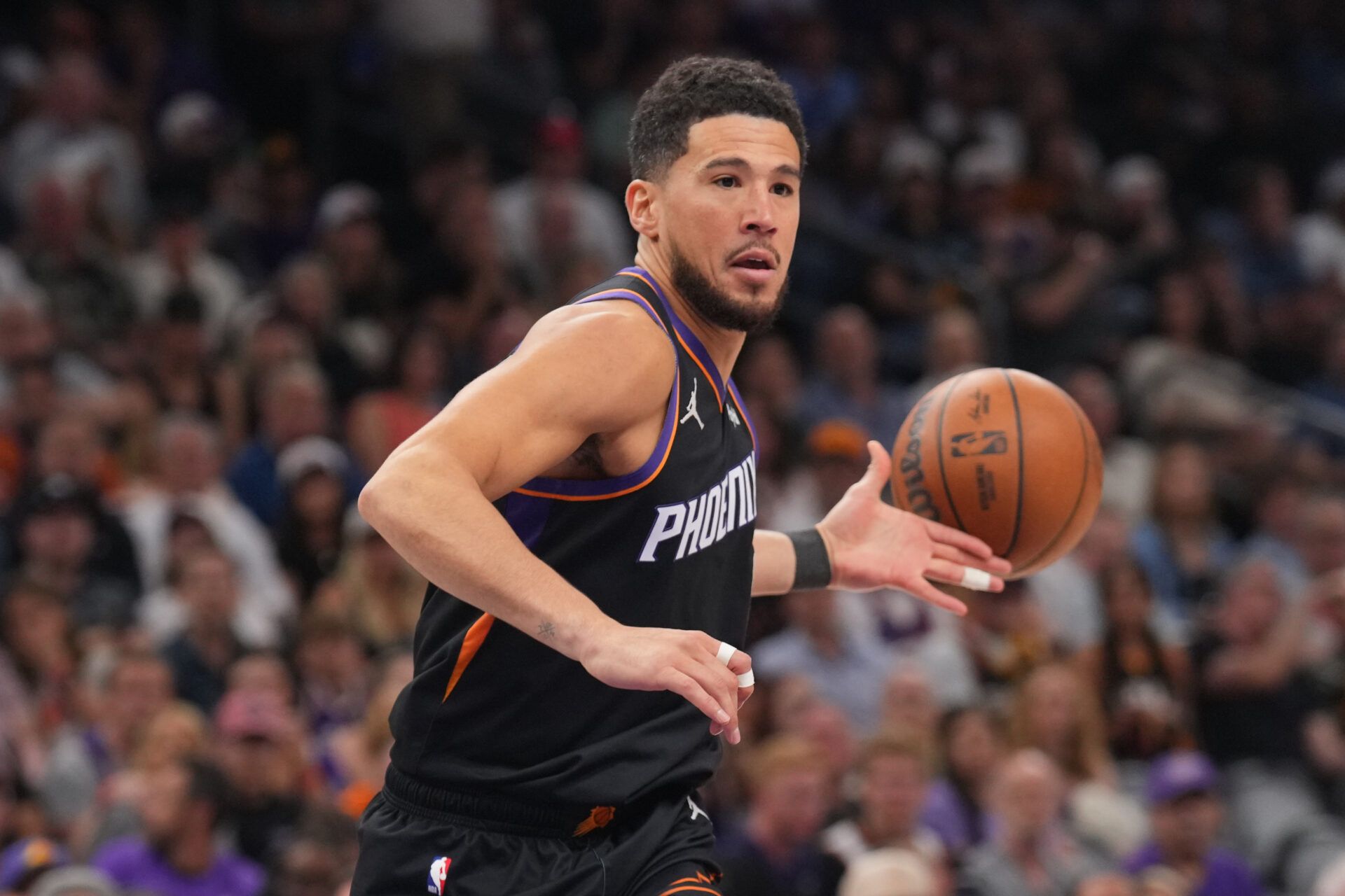 Phoenix Suns guard Devin Booker (1) loses control of the ball against the Milwaukee Bucks during the first half at Mortgage Matchup Center.
