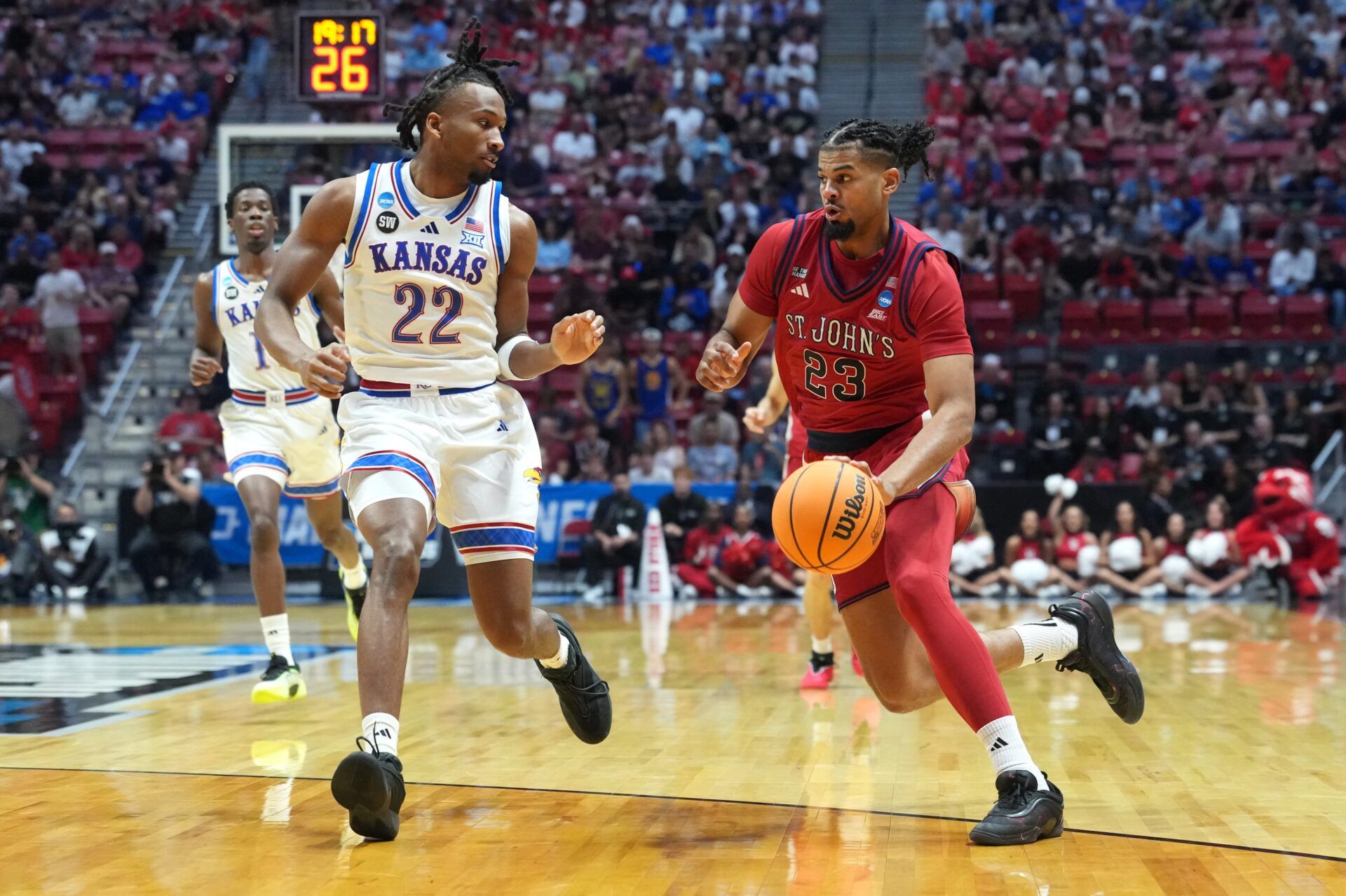 St. John's Red Storm forward Bryce Hopkins (23) controls the ball against Kansas Jayhawks guard Darryn Peterson (22) in the first half during a second round game of the men's 2026 NCAA Tournament at Viejas Arena.