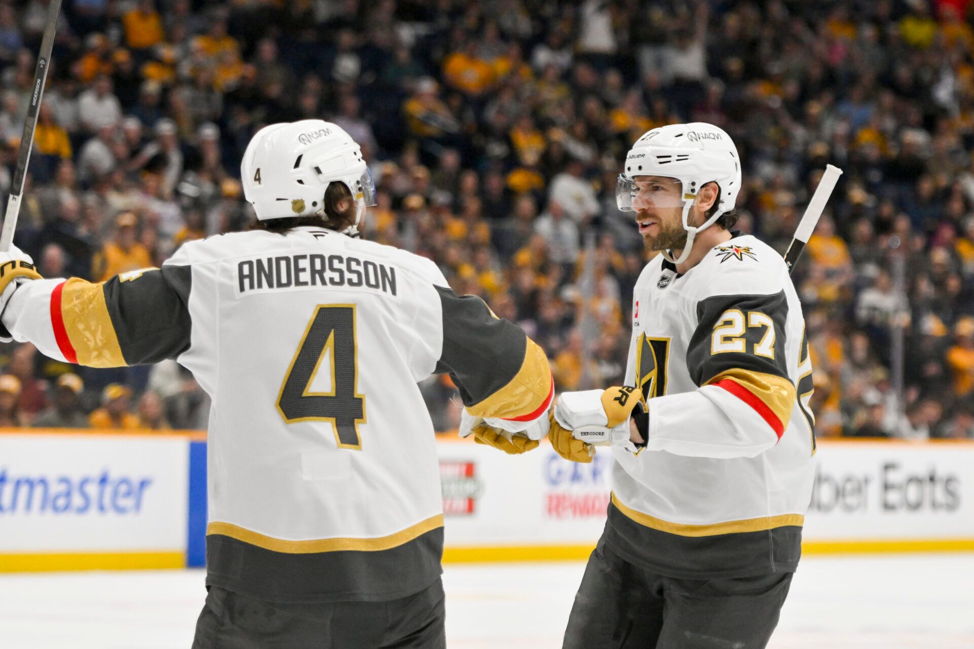 Vegas Golden Knights defenseman Shea Theodore (27) celebrates his goal with defenseman Rasmus Andersson (4) against the Nashville Predators during the third period at Bridgestone Arena.