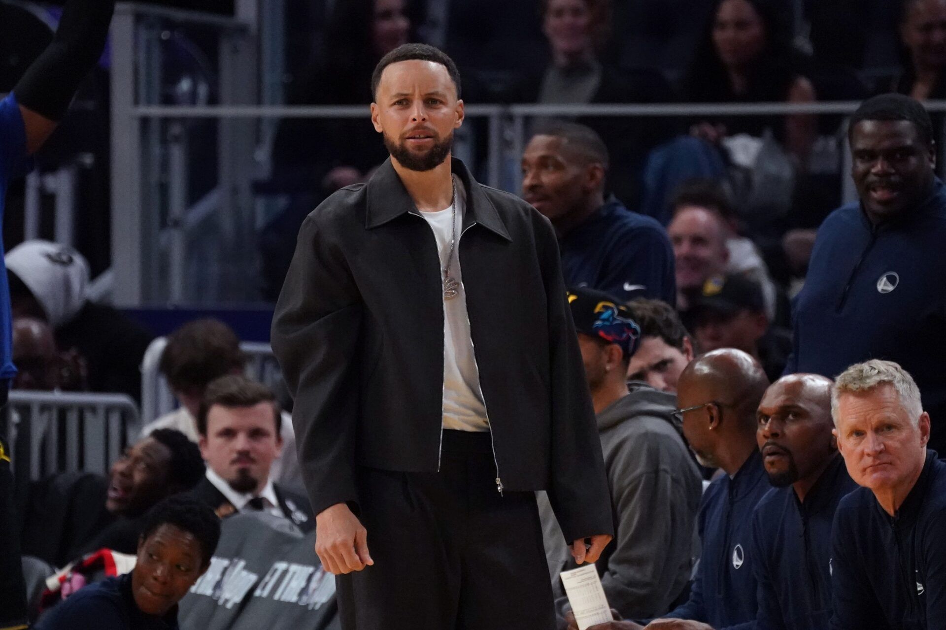 Golden State Warriors guard Stephen Curry (30) watches from the bench in the third quarter during a game against the Denver Nuggets at Chase Center.