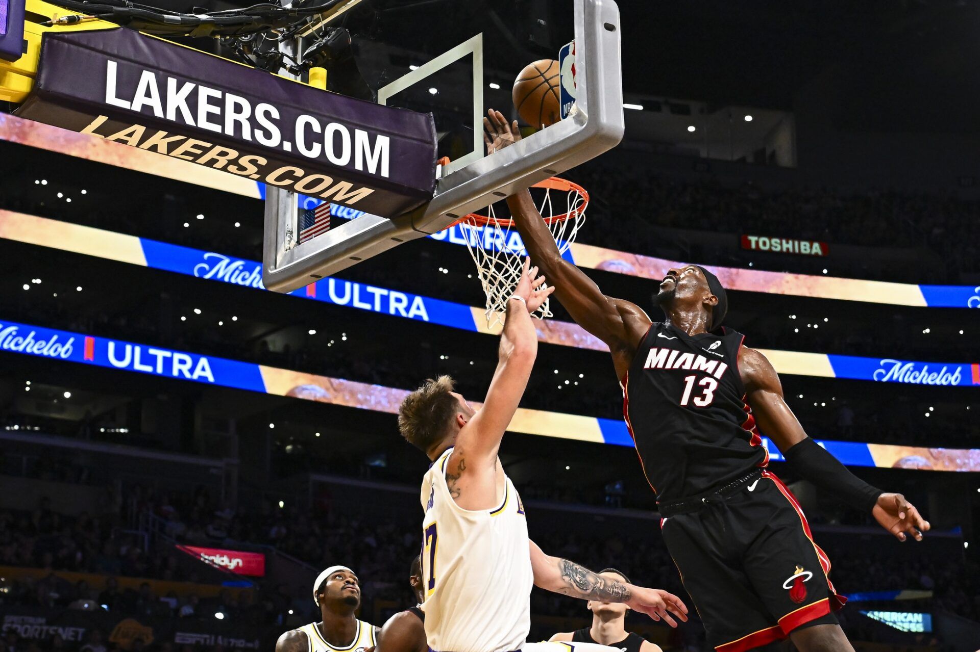Miami Heat center/forward Bam Adebayo (13) shoots against Los Angeles Lakers guard Luka Doncic (77) during the second half at Crypto.com Arena.