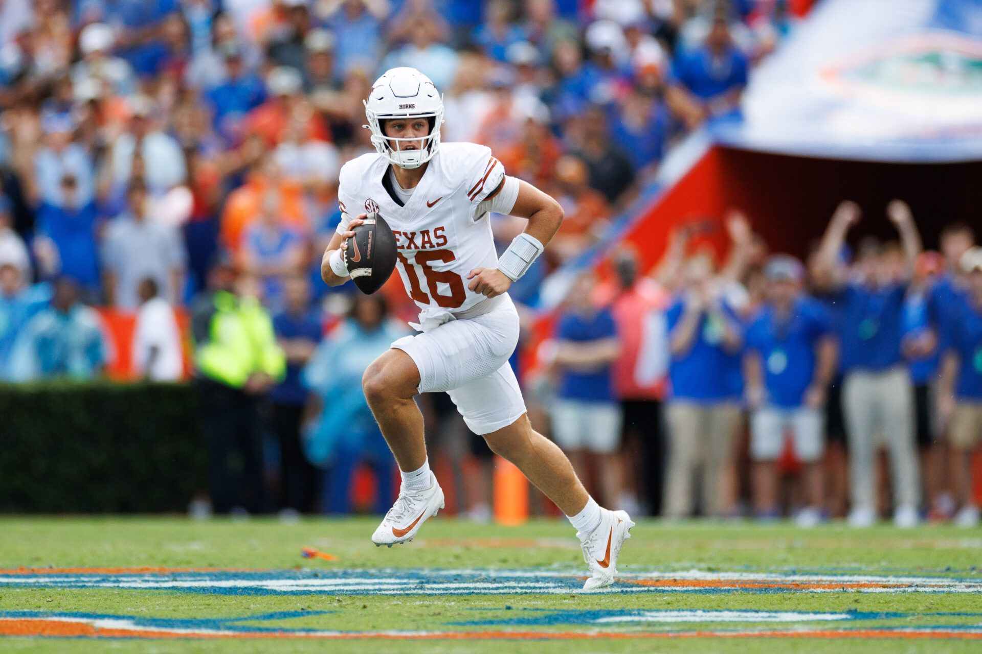 Texas Longhorns quarterback Arch Manning (16) runs with the ball against the Florida Gators during the first half at Ben Hill Griffin Stadium.