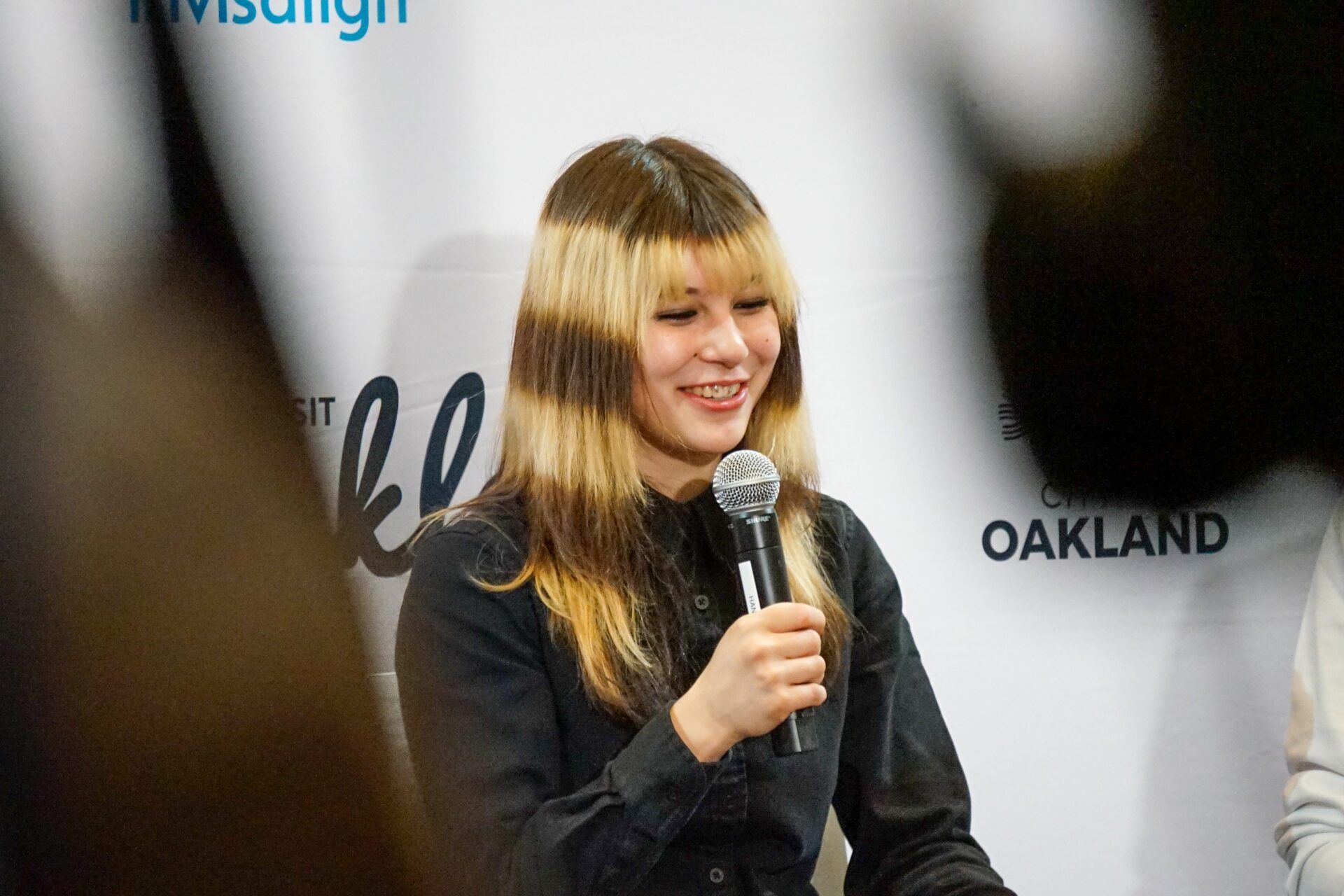 Olympic gold medalist Alysa Liu speaks in a press conference with Mayor Barbara Lee (not in picture), her coach Massimo Scali (not in picture), and choreographer Phillip DeGuglielmo (not in picture) before the City of Oakland hosts its Alysa Liu celebration rally on Thursday, March 13, 2026, in Oakland, CA.