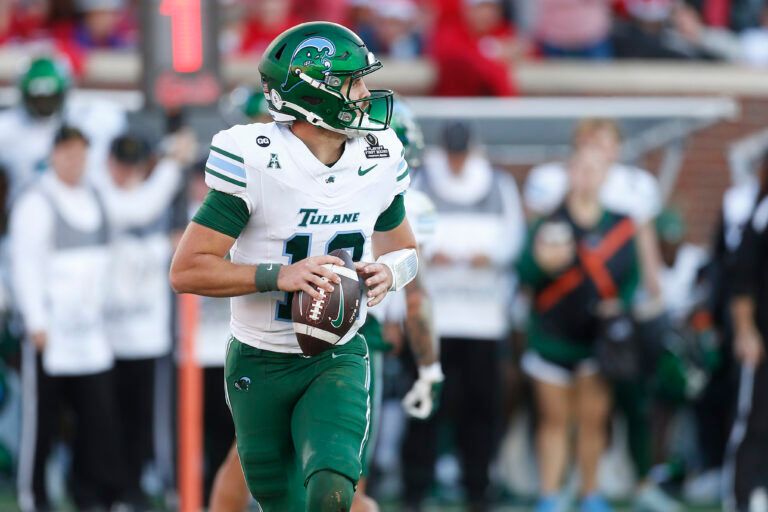 Tulane Green Wave quarterback Jake Retzlaff (12) rolls out against the Mississippi Rebels during the first half of a game at Vaught-Hemingway Stadium.