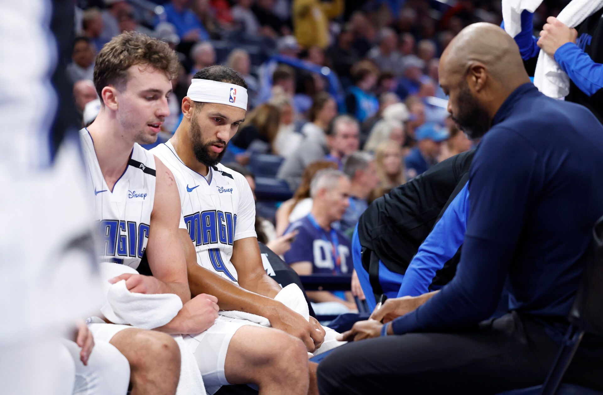 Orlando Magic guard Jalen Suggs (4) and forward Franz Wagner (22) listen to head coach Jamahl Mosley during a time out against the Oklahoma City Thunder in the second half at Paycom Center.
