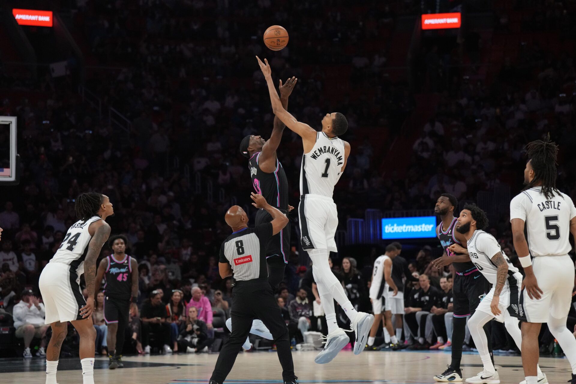 San Antonio Spurs forward Victor Wembanyama (1) wins the tip-off over Miami Heat center Bam Adebayo (13) during the first half at Kaseya Center.
