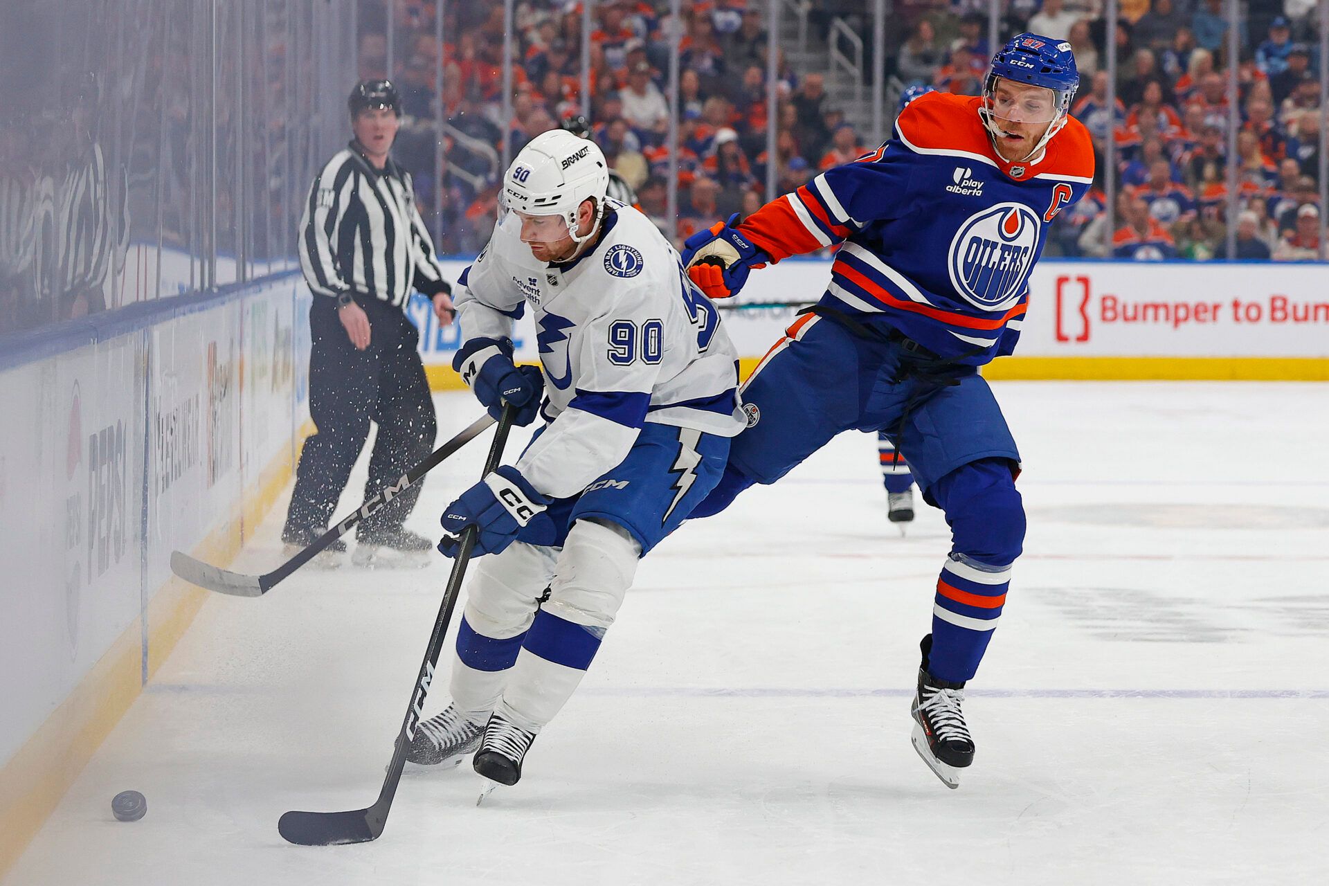 Edmonton Oilers forward Connor McDavid (97) jumps to avoid a hit from Tampa Bay Lightning defensemen J.J. Moser (90) during the first period at Rogers Place.