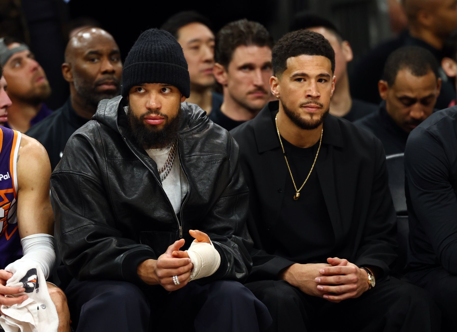 Injured Phoenix Suns forward Dillon Brooks (left) and guard Devin Booker on the bench against the Los Angeles Lakers in the first half at Mortgage Matchup Center.