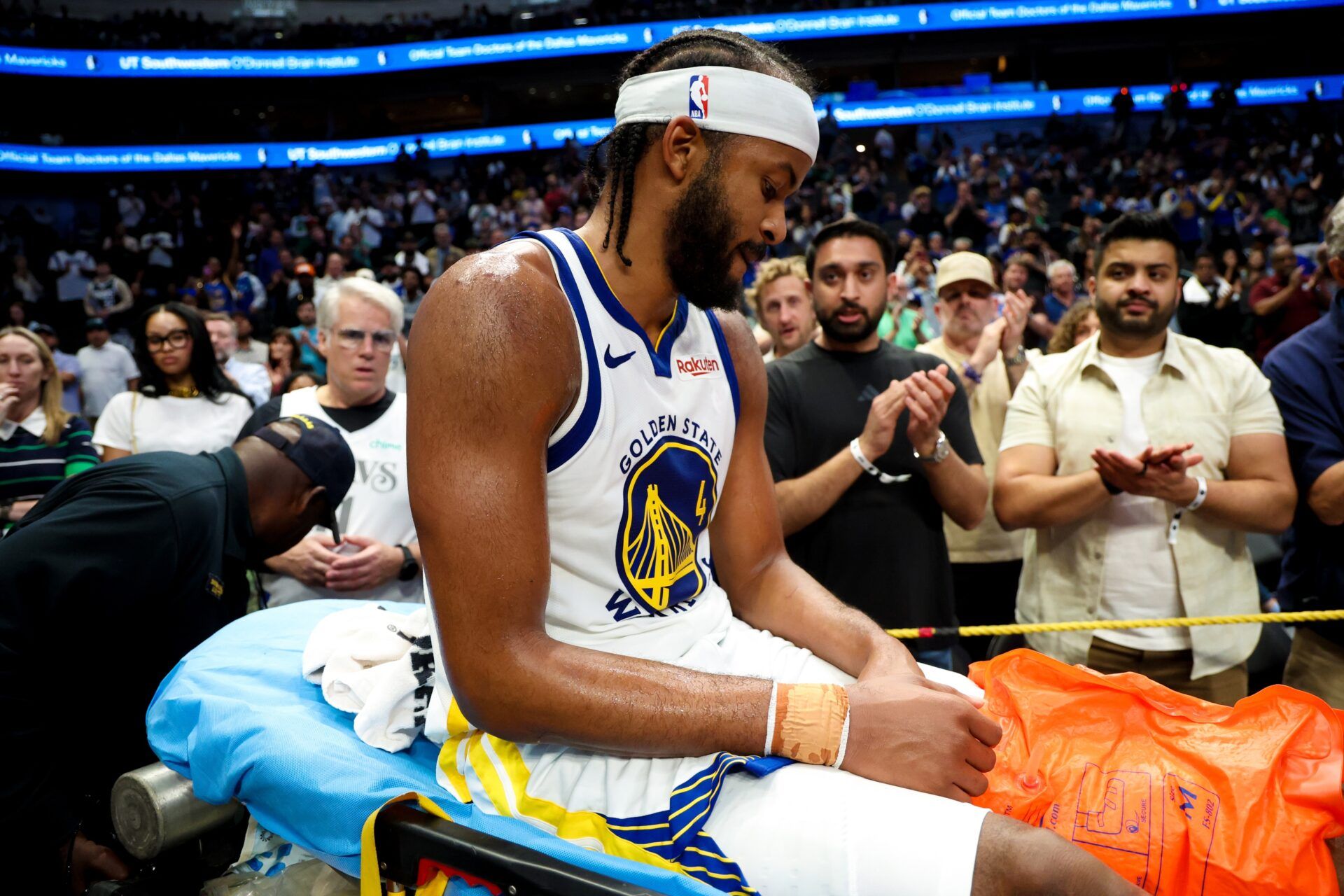 Golden State Warriors guard Moses Moody (4) leaves the court on a stretcher during overtime against the Dallas Mavericks at American Airlines Center.