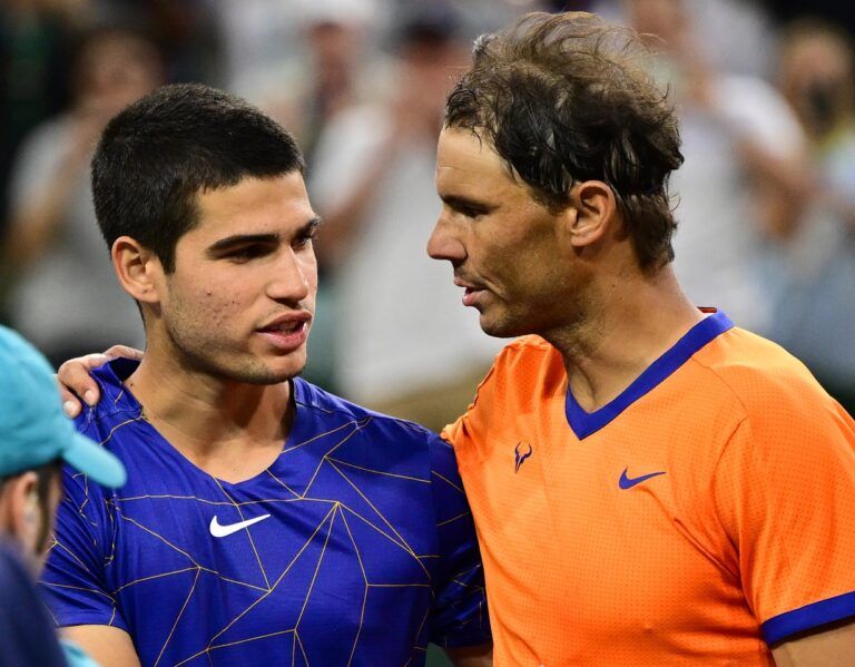 Rafael Nadal (ESP) gripping shakes hands Carlos Alcaraz (ESP) after their semifinal match at the BNP Paribas Open at the Indian Wells Tennis Garden.