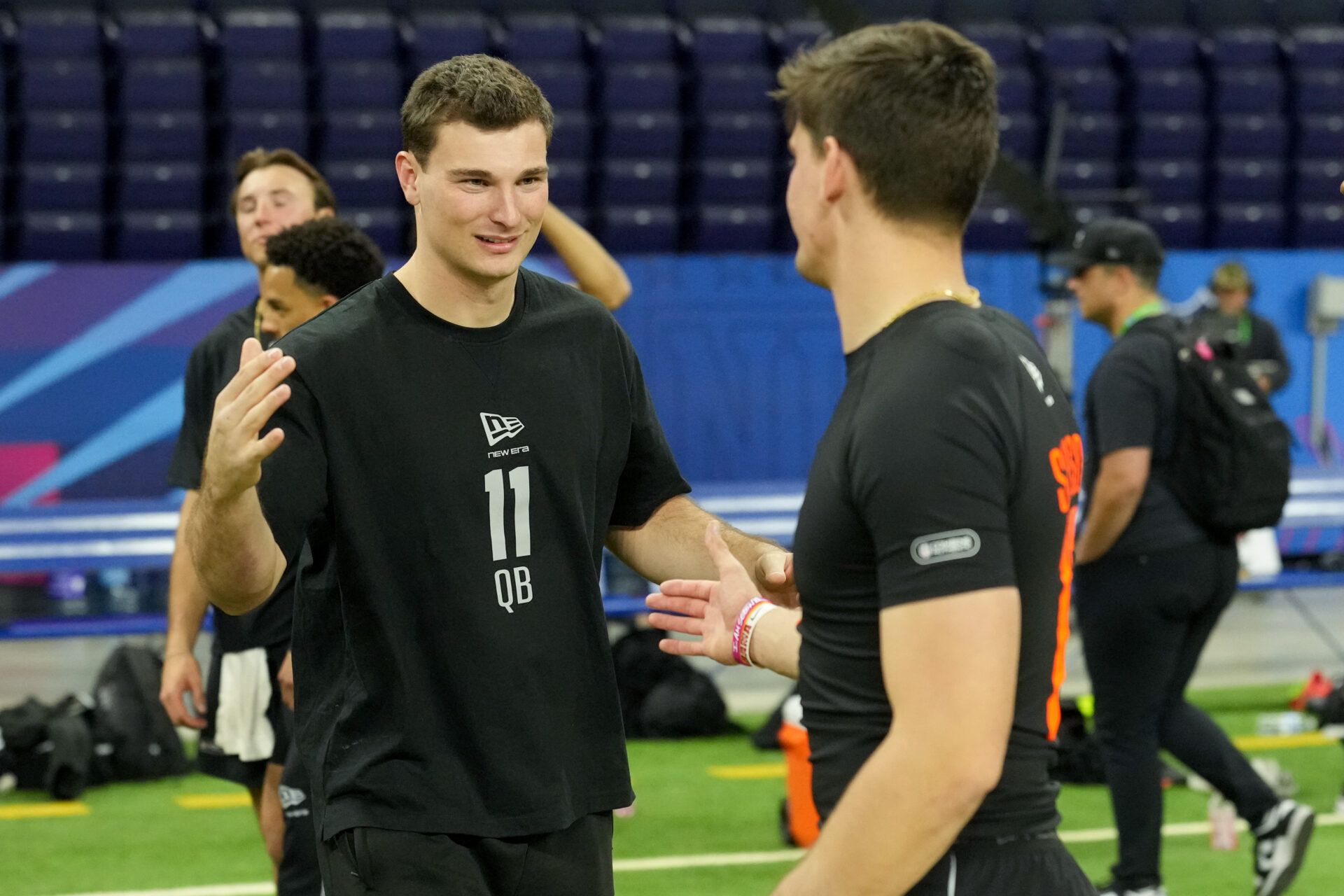 Indiana quarterback Fernando Mendoza (QB11) greets Alabama quarterback Ty Simpson (QB17) during the NFL Scouting Combine at Lucas Oil Stadium.