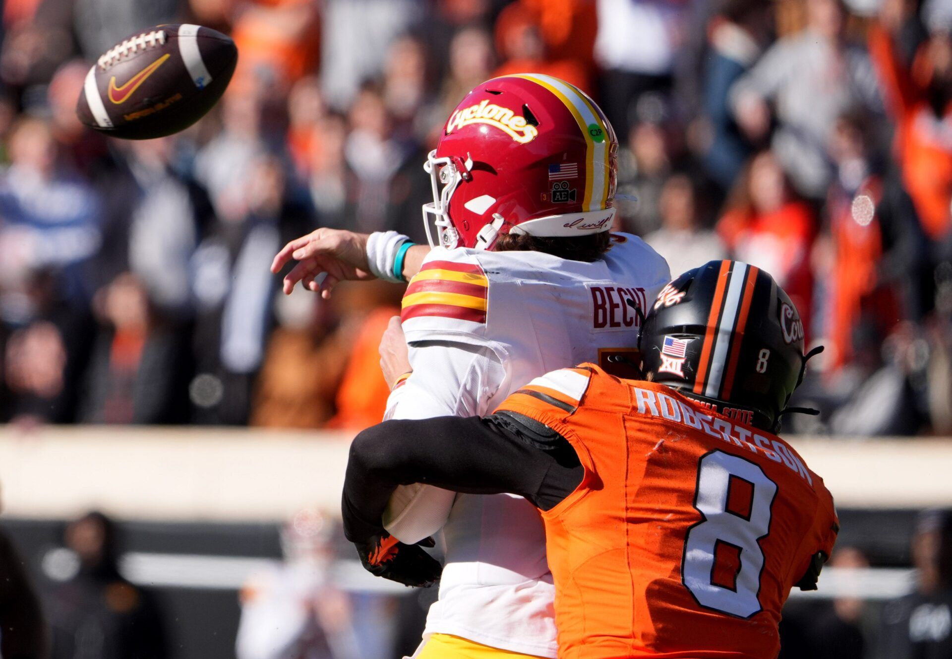 Oklahoma State's Parker Robertson (8) hits Iowa State's Rocco Becht (3) as he throws in the second half of the college football game between the Oklahoma State Cowboys and the Iowa State Cyclones at Boone Pickens Stadium in Stillwater, Okla., Saturday Nov. 29, 2025.