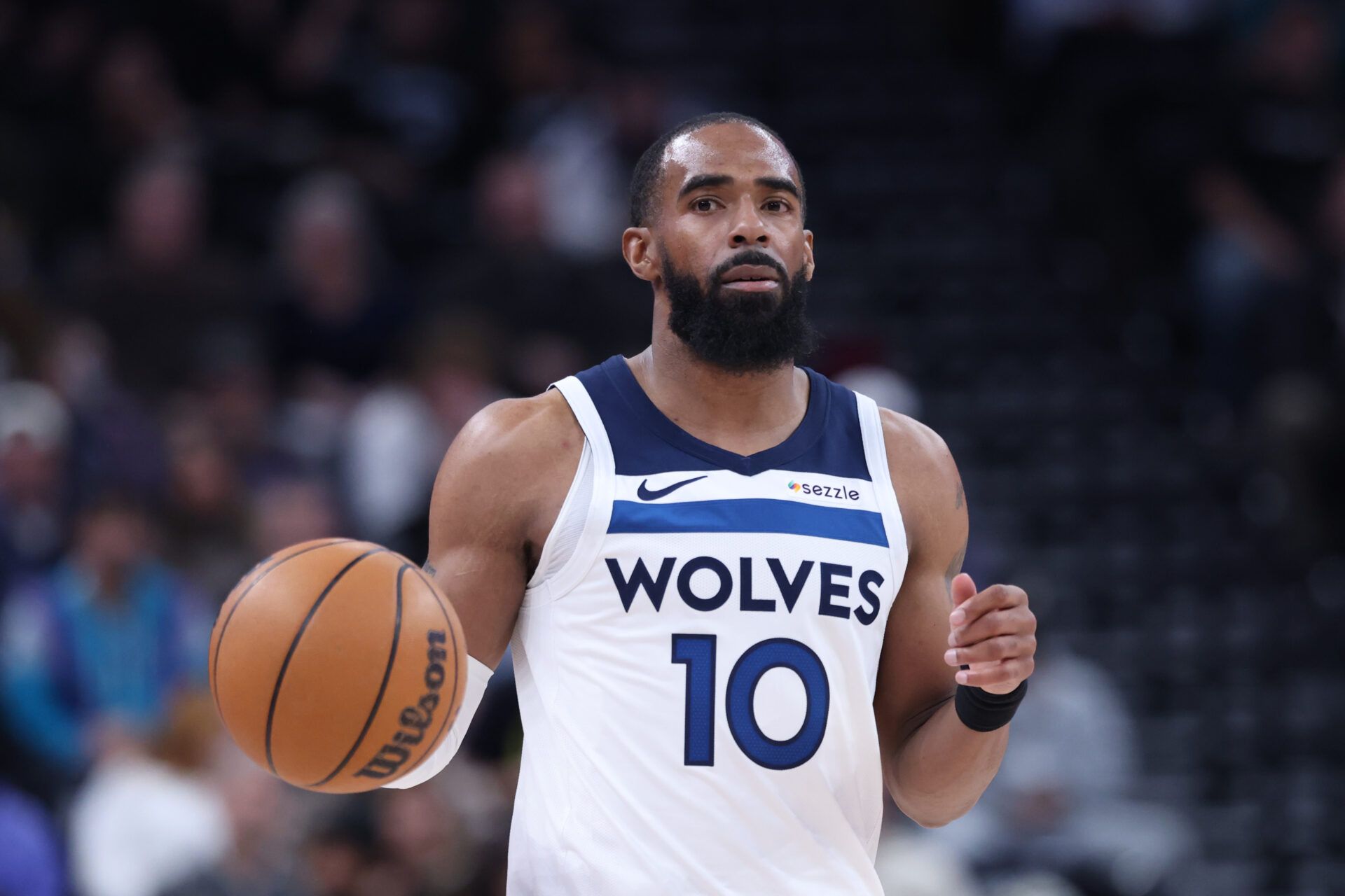 Minnesota Timberwolves guard Mike Conley (10) bring the ball up the court against the Utah Jazz during the second half at Delta Center.