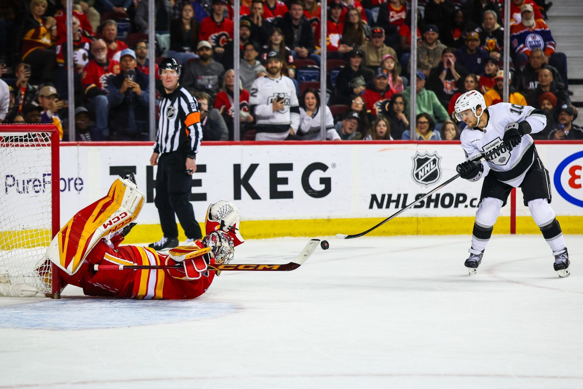 Los Angeles Kings left wing Artemi Panarin (10) scores a goal against Calgary Flames goaltender Dustin Wolf (32) during the shootout period at Scotiabank Saddledome.