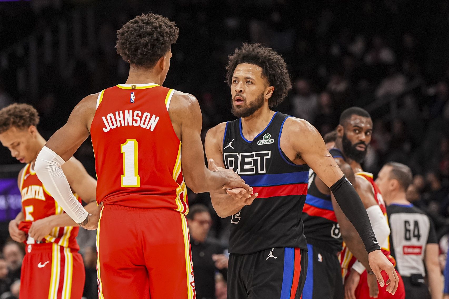 Detroit Pistons guard Cade Cunningham (2) and Atlanta Hawks forward Jalen Johnson (1) react after the Pistons defeated the Hawks at State Farm Arena.