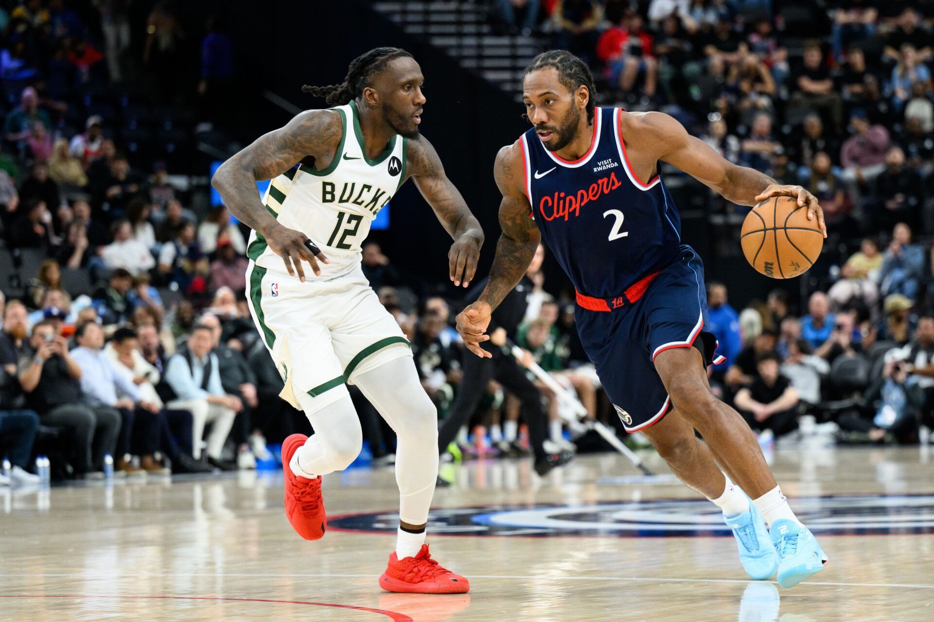 Los Angeles Clippers forward Kawhi Leonard (2) drives the ball while under pressure from Milwaukee Bucks forward Taurean Prince (12) during the first half at Intuit Dome.