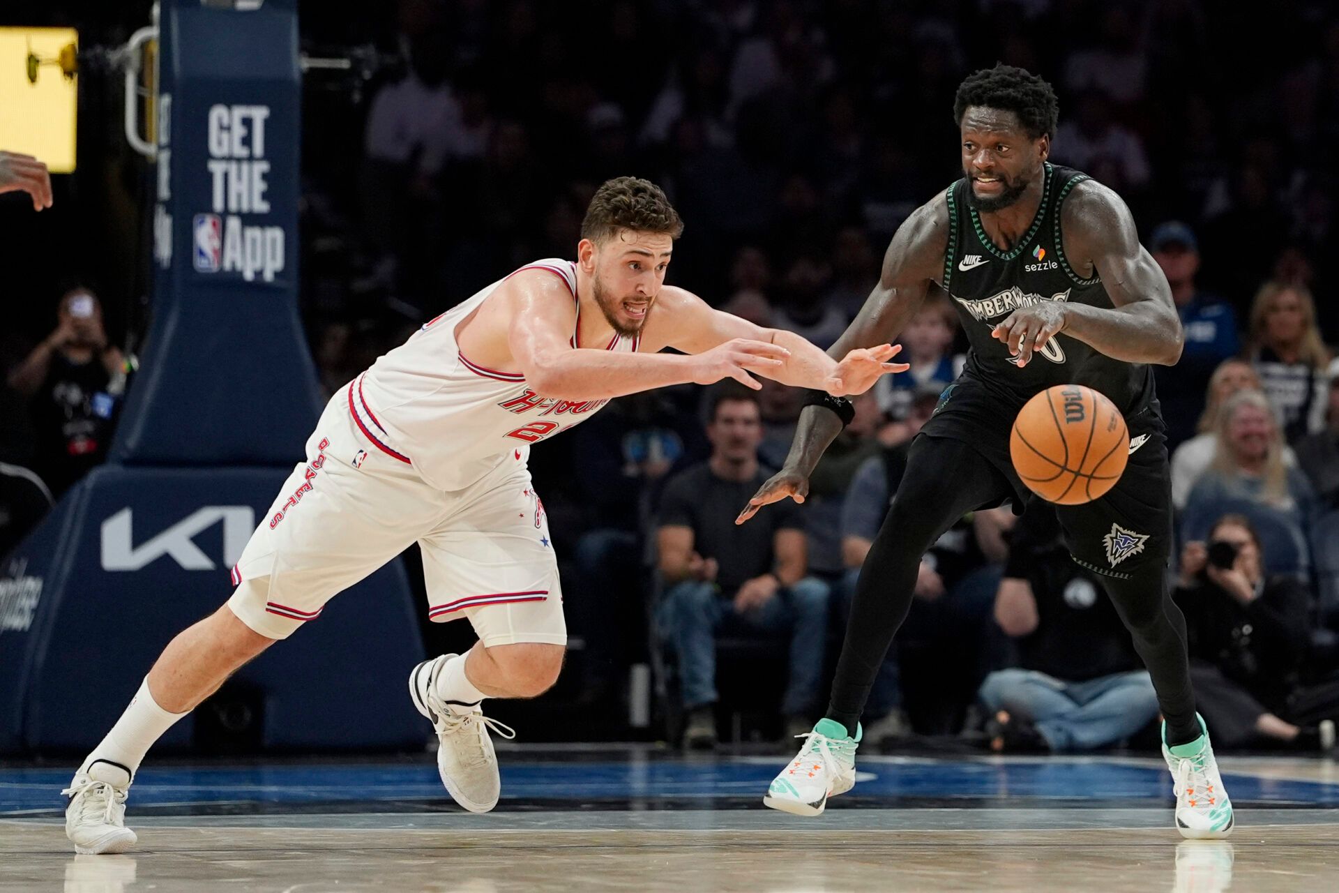 Houston Rockets center Alperen Sengun (28) challenges Minnesota Timberwolves forward Julius Randle (30) for the ball in the fourth quarter at Target Center.