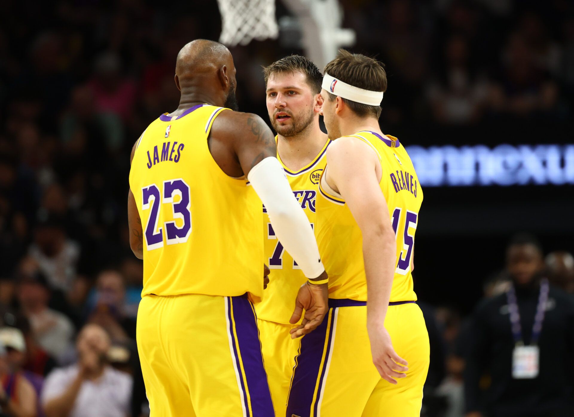 Los Angeles Lakers forward LeBron James (23) with guard Luka Doncic (77) and guard Austin Reaves (15) against the Phoenix Suns at Mortgage Matchup Center.