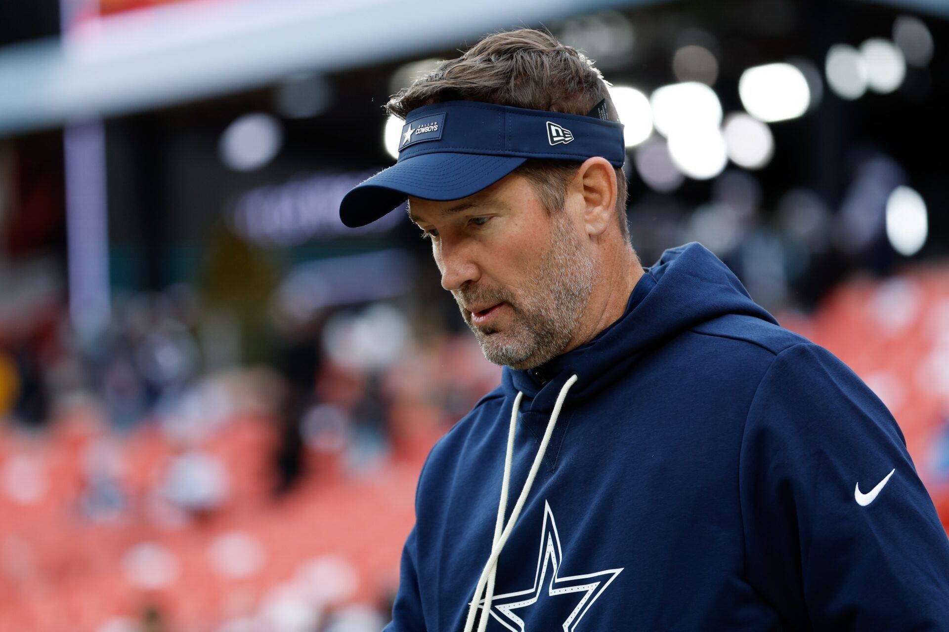 Dallas Cowboys head coach Brian Schottenheimer looks on during warmups before the game against the Washington Commanders at Northwest Stadium.