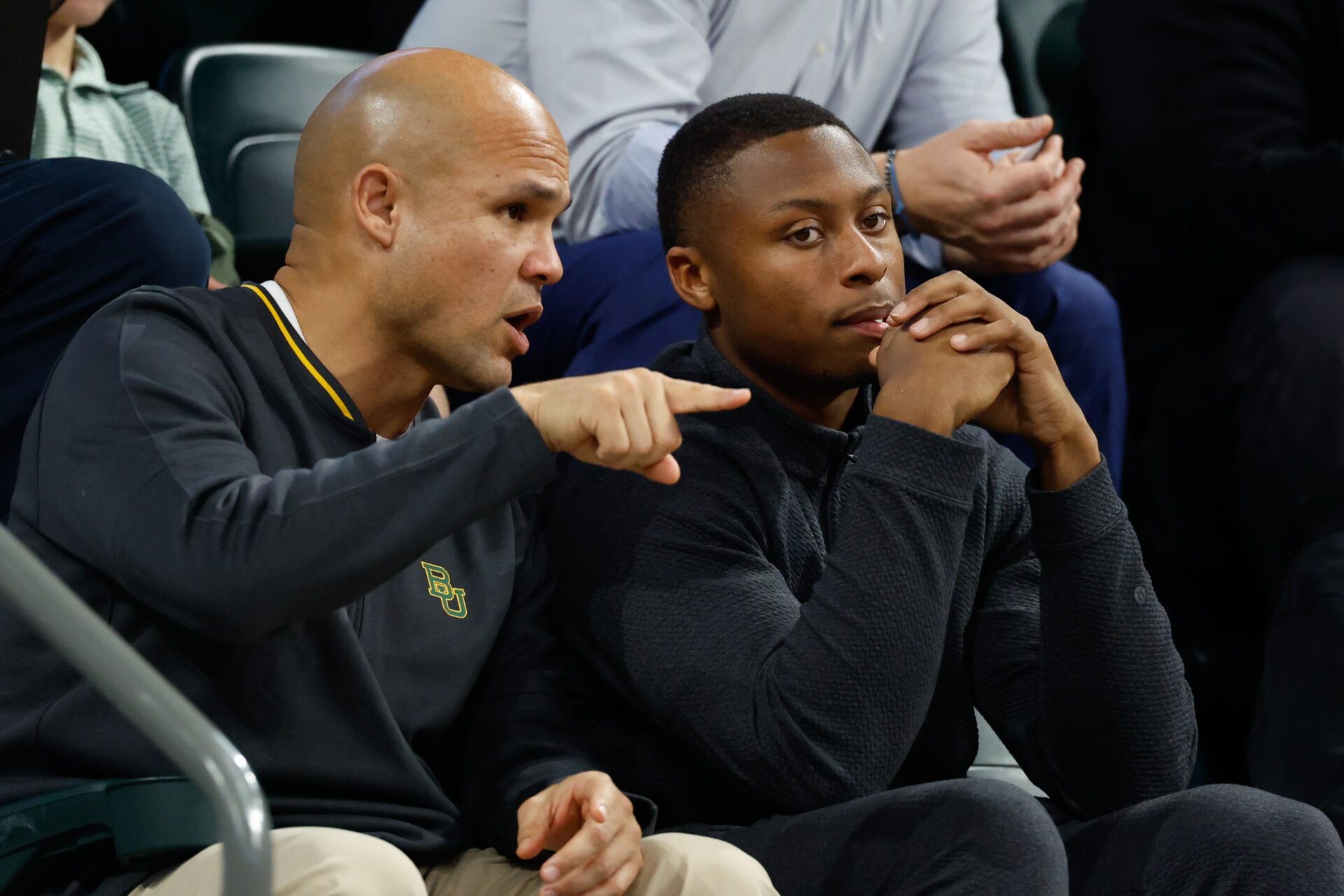 DJ Lagway, a Florida quarterback currently in the transfer portal, sits with Baylor Bears football head coach Dave Aranda, left, during the first half of a game between the Baylor Bears and Iowa State Cyclones at Paul and Alejandra Foster Pavilion.