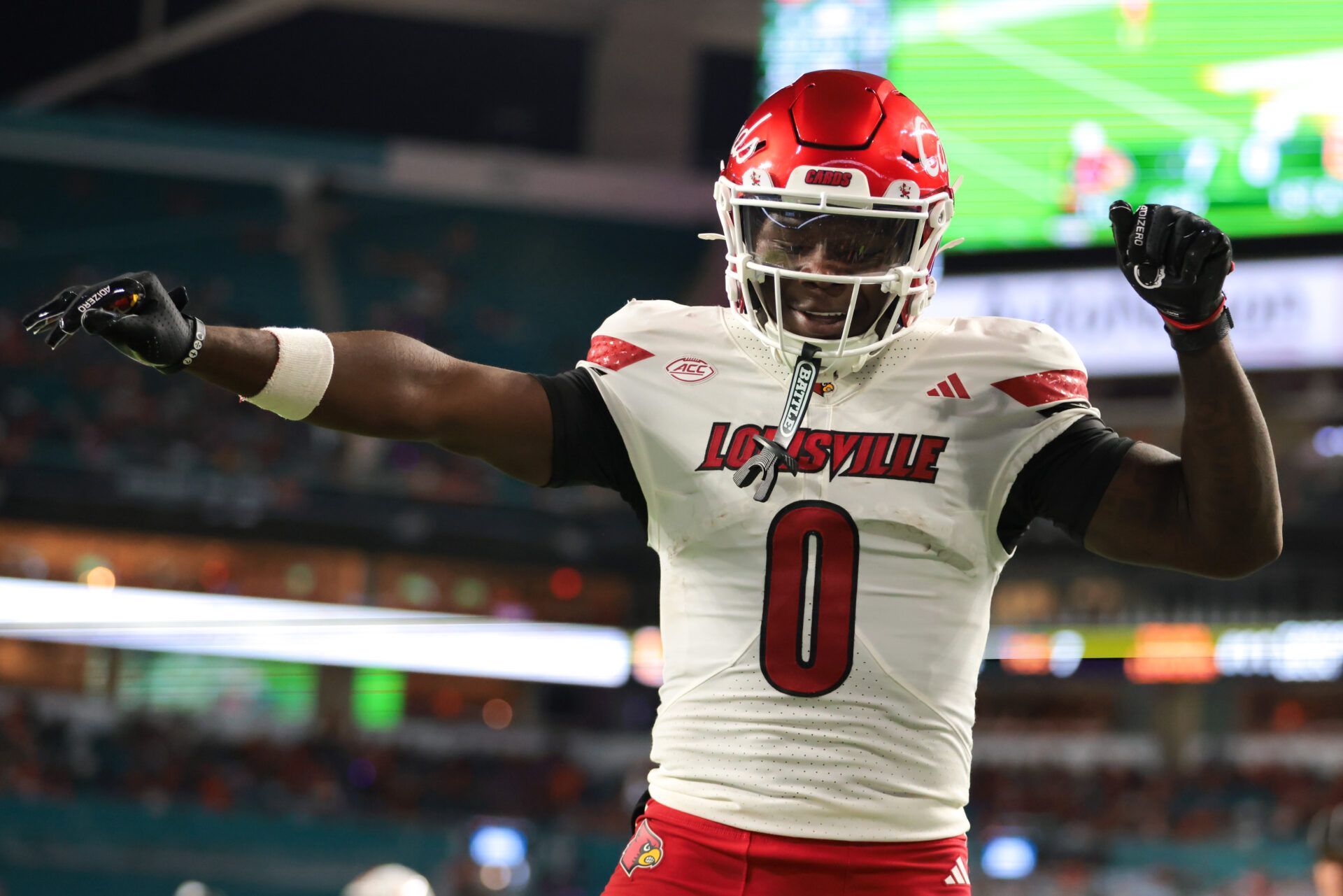 Louisville Cardinals wide receiver Chris Bell (0) celebrates after scoring a touchdown against the Miami Hurricanes during the first quarter at Hard Rock Stadium.