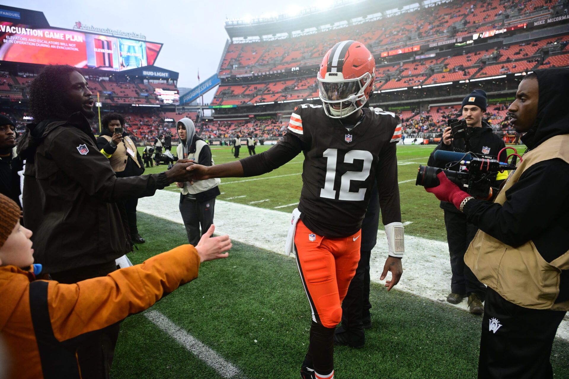 Cleveland Browns quarterback Shedeur Sanders (12) greets former NFL player Tony Brown before the game against the Pittsburgh Steelers at Huntington Bank Field.