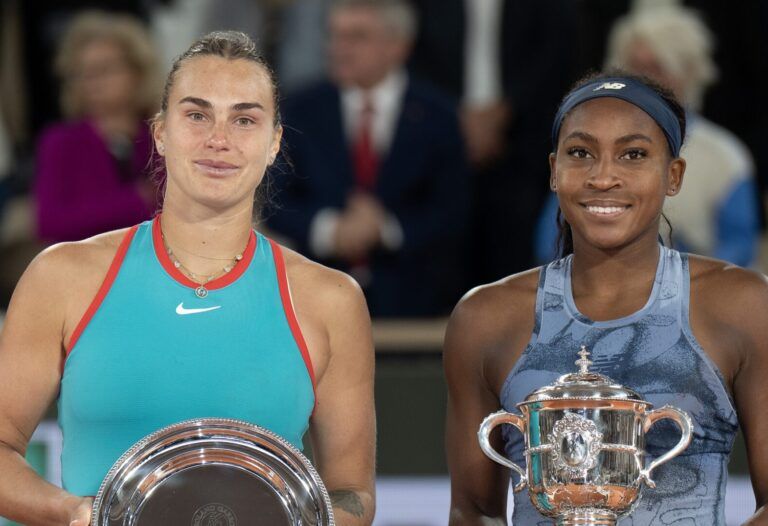 Coco Gauff of the United States poses with Aryna Sabalenka after their match on day 14 at Roland Garros Stadium.