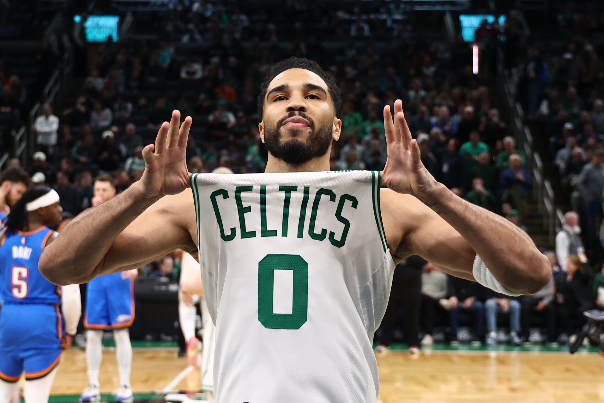 Boston Celtics forward Jayson Tatum (0) shows off his jersey before their game against the Oklahoma City Thunder at TD Garden.