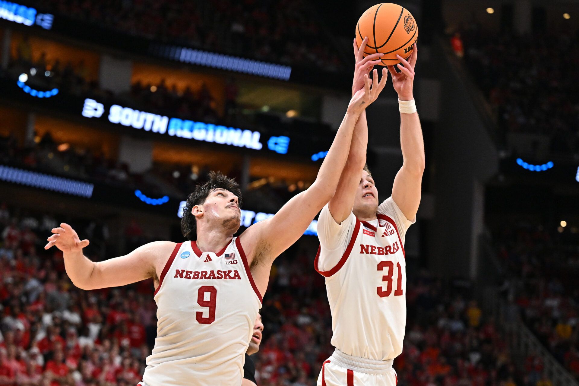 Nebraska Cornhuskers forward Berke Buyuktuncel (9) and guard Cale Jacobsen (31) grab a rebound against the Iowa Hawkeyes in the second half during a Sweet Sixteen game of the South Regional of the men's 2026 NCAA Tournament at Toyota Center.